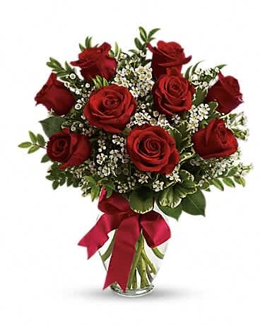 Bouquet of red roses with baby's breath in a glass vase