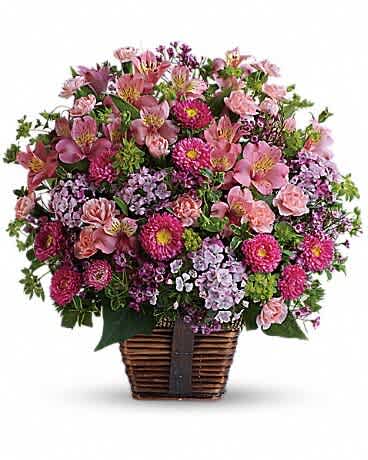 Basket arrangement of pink and purple flowers