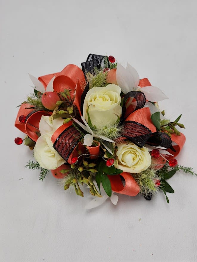 Cream roses with red and black ribbon accents