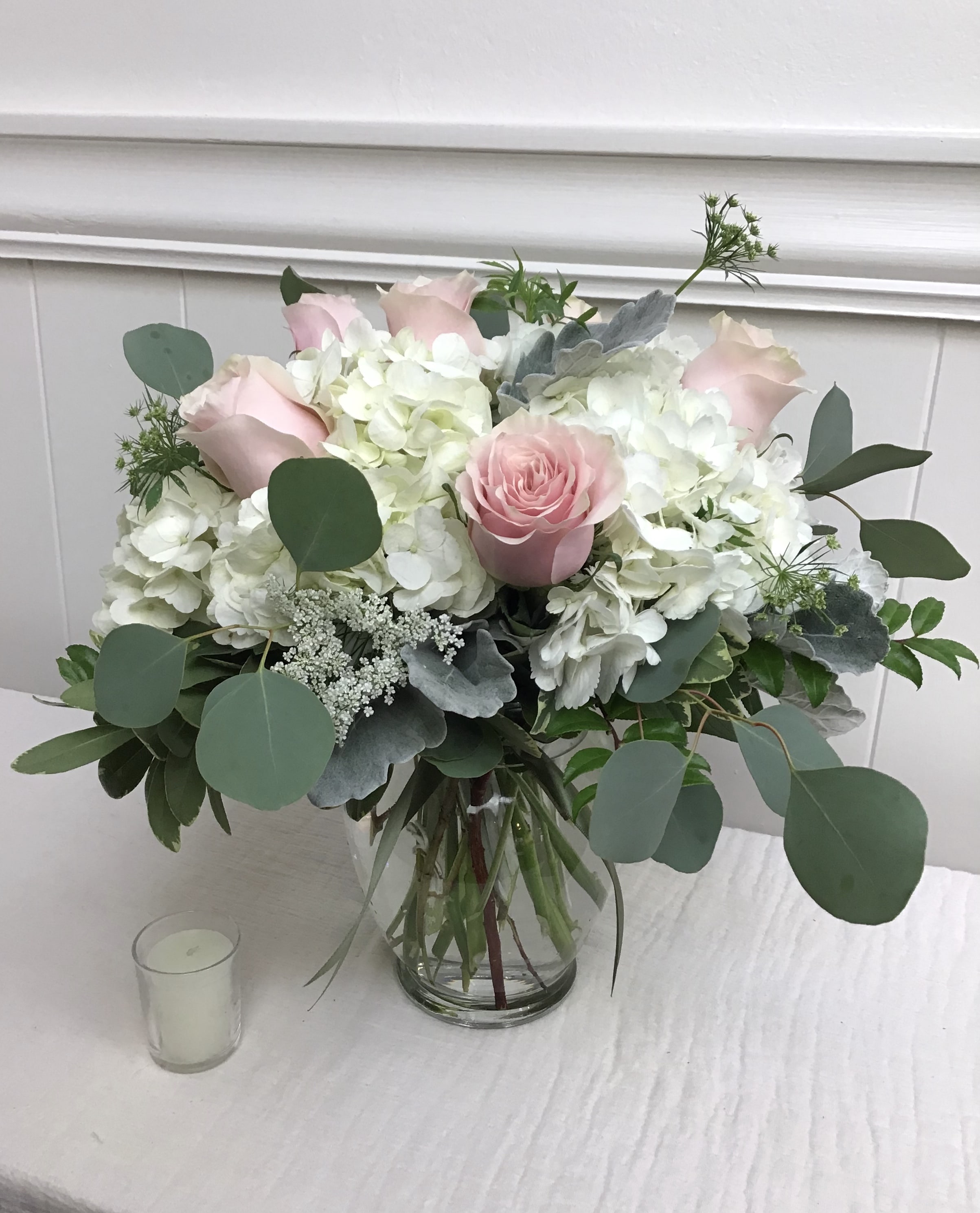 Pink roses and white hydrangeas in a glass vase