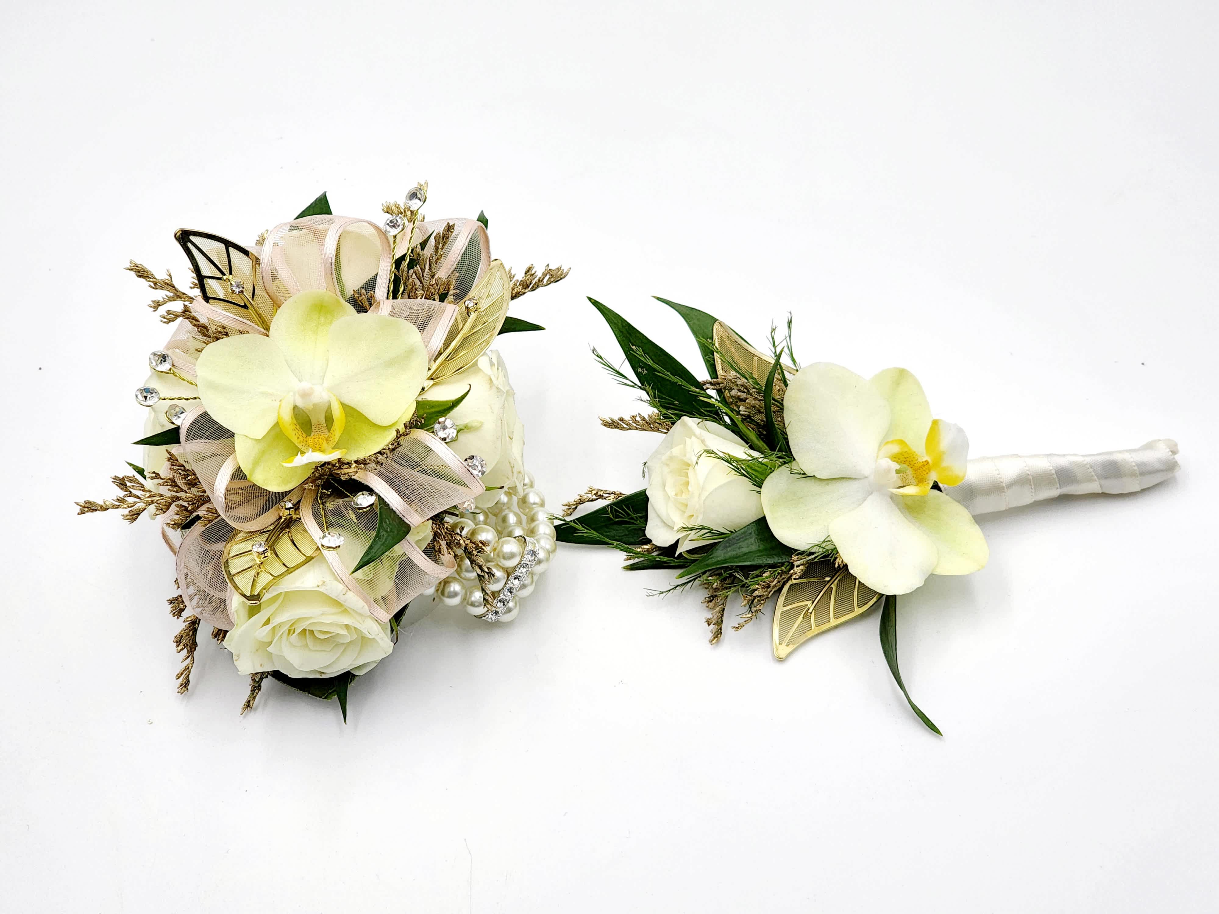 Monarch's Choice Boutonniere And Wristlet Set - A boutonniere and wrist corsage set featuring pale yellow phaleonopsis orchids, white spray roses, clear rhinestones, light pink ribbons and gold leaf accents. Also features a pearl bracelet.  Depending on availability of ribbon, may change slightly.
