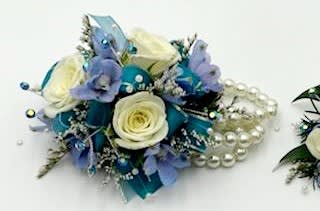 Blue and white floral corsage with pearl accents