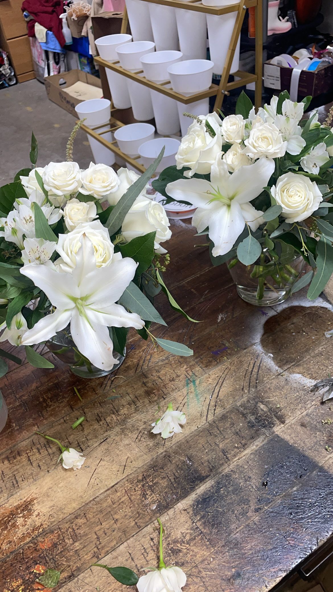  perfect mini centerpieces - Pure white lilies and creamy roses clustered into low, rounded bouquets create a calm, refined centerpiece ideal for a Mother's Day table, a sympathy gesture, or an elegant anniversary gift. These mini centerpieces present the flower arrangement and occasion-wedding, get well, birthday, or just-because-with a soft, formal look that still fits everyday rooms; the fresh white palette reads as peaceful for Memorial Day or Easter while remaining perfectly at home for Christmas or winter gatherings.  Each compact arrangement combines fragrant white lilies, creamy white roses, and delicate alstroemeria arranged tightly in a clear glass vase for a clean, classic profile. The low height makes these perfect for tabletops, office desks, or bedside stands without blocking sightlines; the rounded silhouette and all-white blooms give a polished, cohesive texture that complements seasonal décor from spring through autumn. Ideal for housewarmings, graduations, thank-you gifts, or sympathy and funeral settings, these mini centerpieces make the recipient feel noticed and comforted.  Available in small, easy-to-place sizes, these vases are ready to display on arrival-just add fresh water and trim stems as needed every few days to keep blooms looking their best. Order for holidays like Thanksgiving or Hanukkah, occasions like Mother's Day and Valentine's Day, or simply to say "thinking of you" or "I'm sorry"; the restrained white design sends a gentle, heartfelt message for nearly any moment.