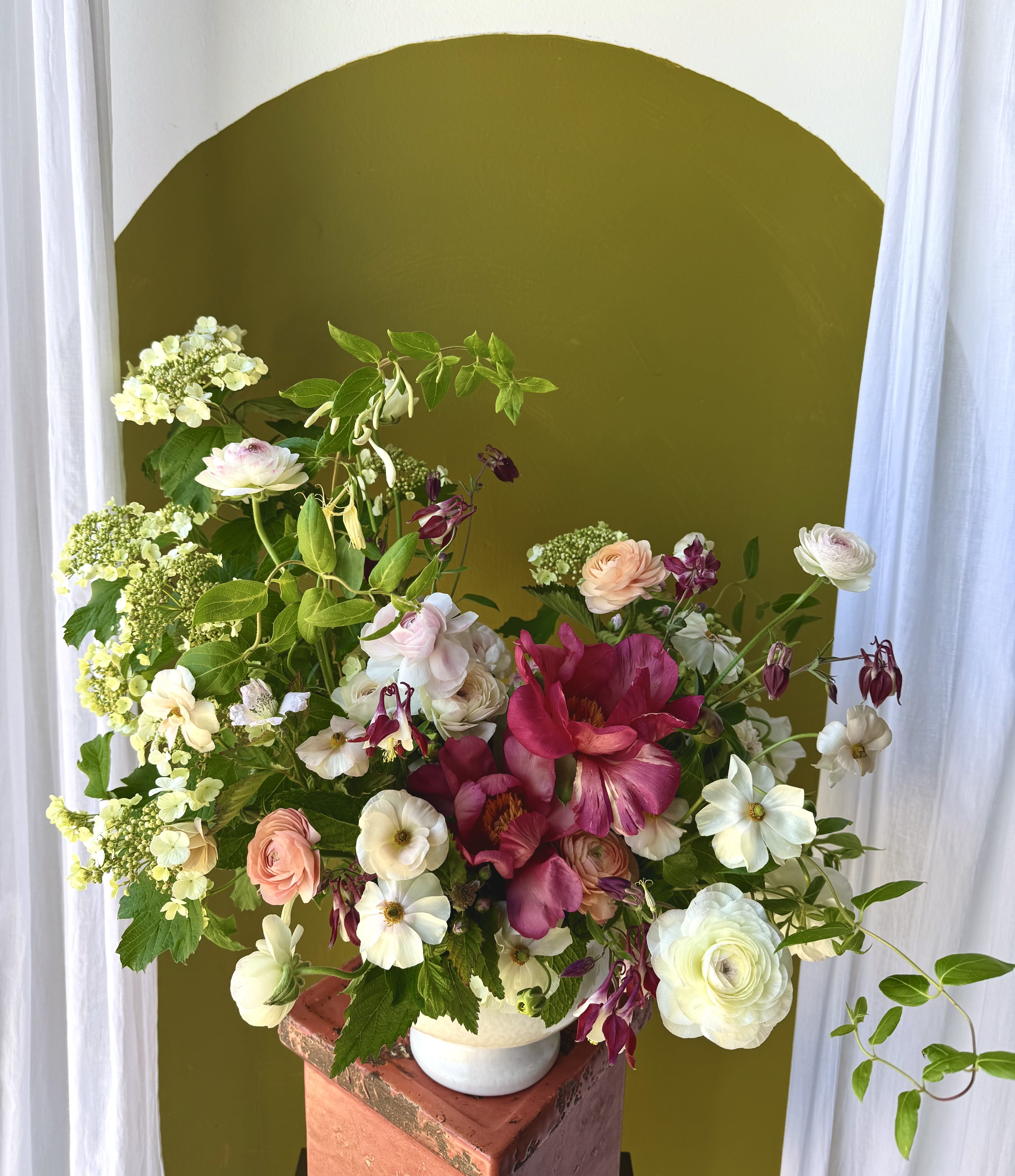 Mother's Day Soft Arrangement - A beautiful garden-style arrangement packed with spring blooms in a soft color palette. Fashioned in a large white compote.   Concerning Seasonality: As a seasonal, locally-focused florist, we have different product to work with each week. Our focus is on creating a unique piece for each customer, with blooms that are fresh from local farms and growers. While the flower varieties and colors may vary, the quality and freshness will always be the best. It is an honor to have our customers' trust and confidence in our abilities and artistic eye.   Delivery Policy: Pick-ups at the studio are available after 2pm. Our daily delivery time frame is typically between 12- 3 PM. Please specify if you require a certain delivery time and we will do our best to accommodate it, or we will call you if we cannot. Please include any gate codes if applicable! If there is no answer at the door, our delivery person will leave the flowers by the doorstep in a weather safe location or contact you to reschedule the delivery.  Completing your order acknowledges that you have read and understand our delivery policies. 