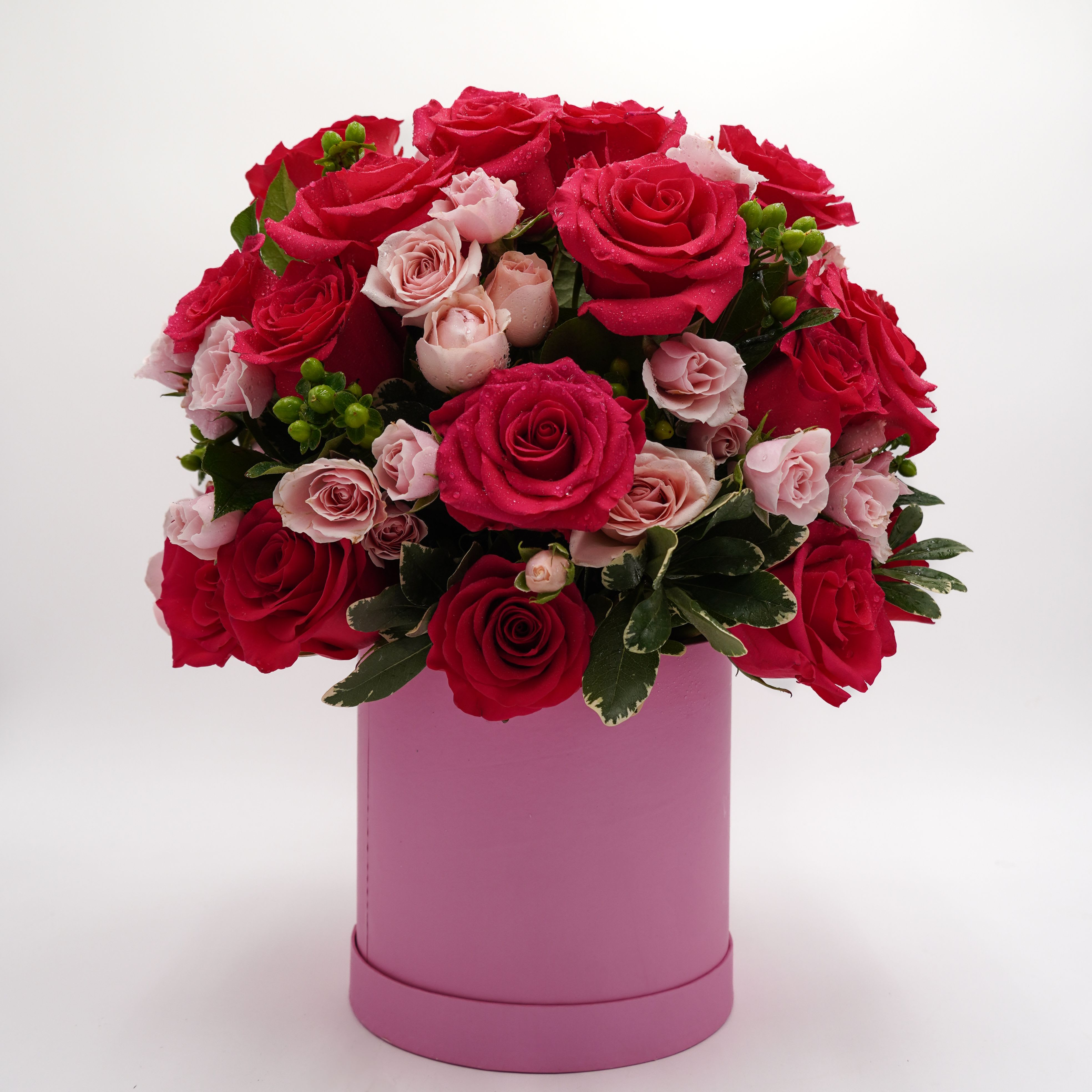 Bouquet of red and pale pink roses in a pink box