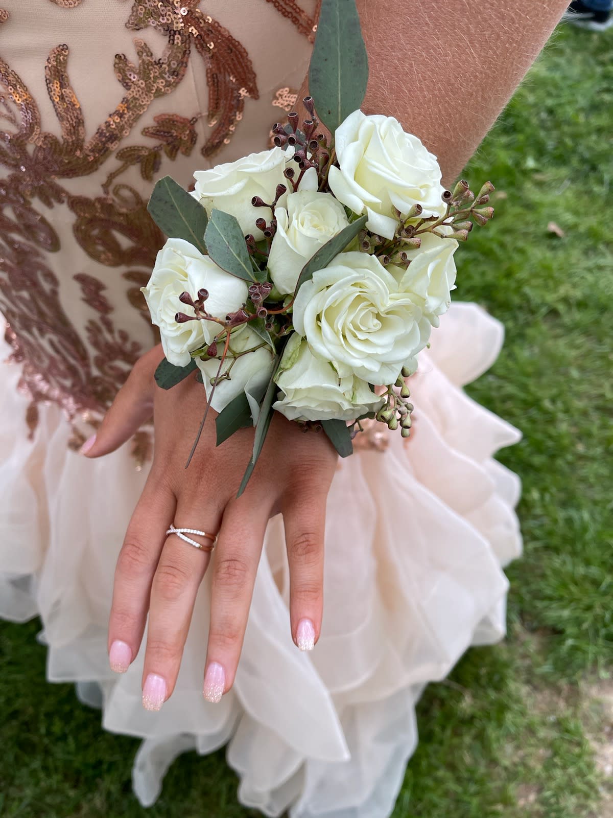 Wristlet  - White spray roses, accented with eucalyptus seed wristlet.
