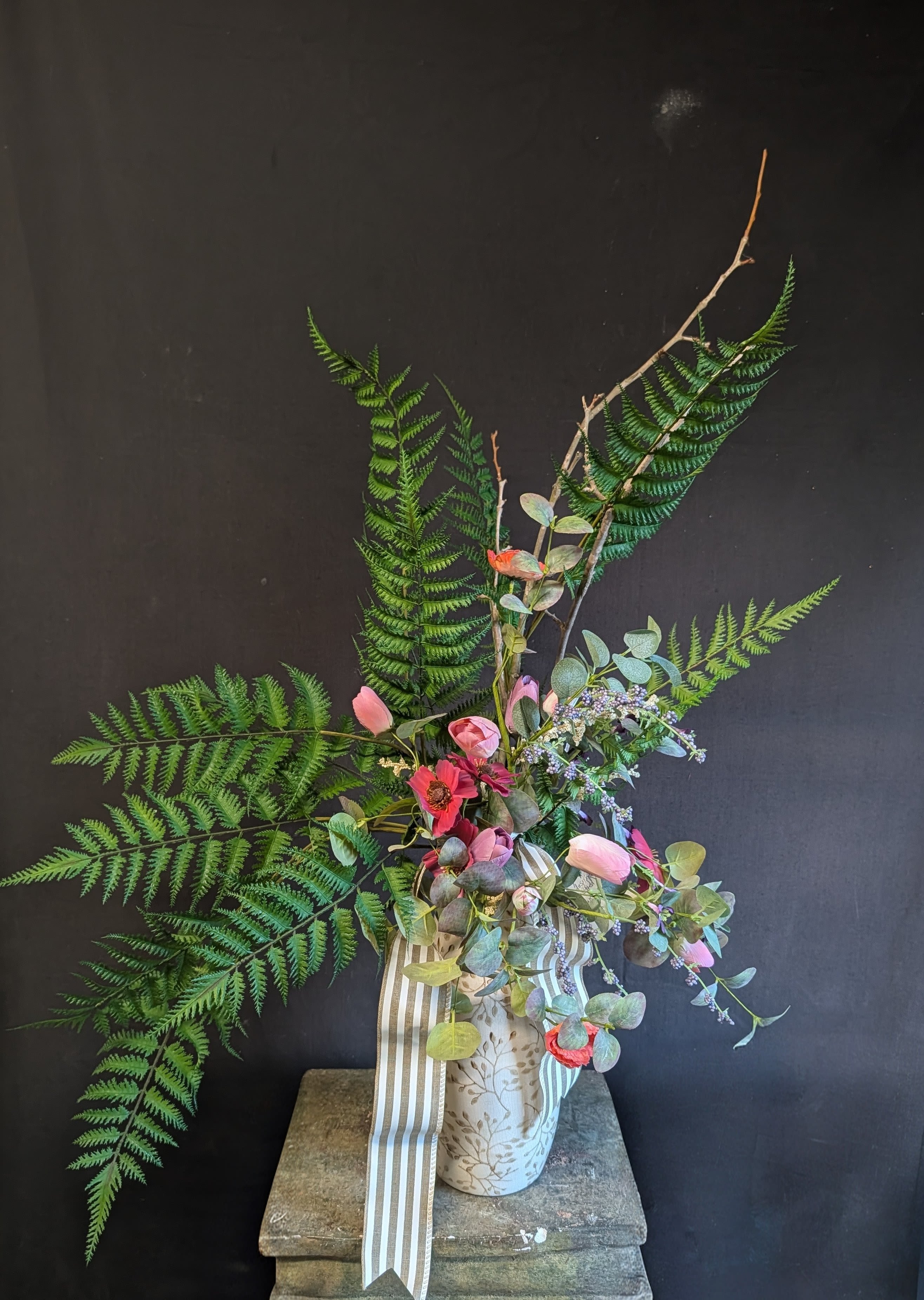 Fern Blooms Permanent Botanical  - Elevate your décor with this elegant faux bouquet arrangement featuring a soft mix of ferns, tulips, anemone flowers, and mixed eucalyptus greenery. Artfully arranged in a neutral cream vase with a delicate vine design, this artificial flower arrangement adds timeless charm to any room.  Perfect for:   - Dining table or coffee table centerpieces   - Entryway and console table décor   - Wedding and bridal shower decorations   - Long-lasting home or office floral arrangements  