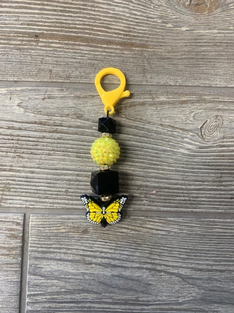 Yellow butterfly beaded charm with black beads and a clip