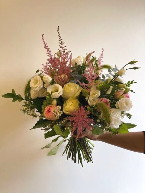 Handheld bouquet of white and pink flowers with tall pink accents