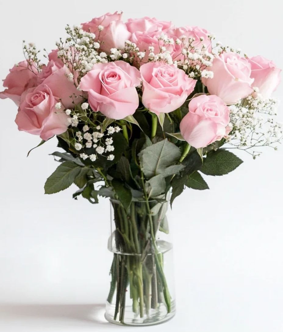 Blush Serenity Bouquet - Delicate and timeless, the Blush Serenity Bouquet features 12 soft pink roses beautifully accented with airy sprigs of baby’s breath. Arranged in a clear glass vase, this elegant display radiates grace and gentle charm — perfect for celebrating love, gratitude, or simply brightening someone’s day. Ideal for birthdays, anniversaries, or as a heartfelt “just because” gesture.