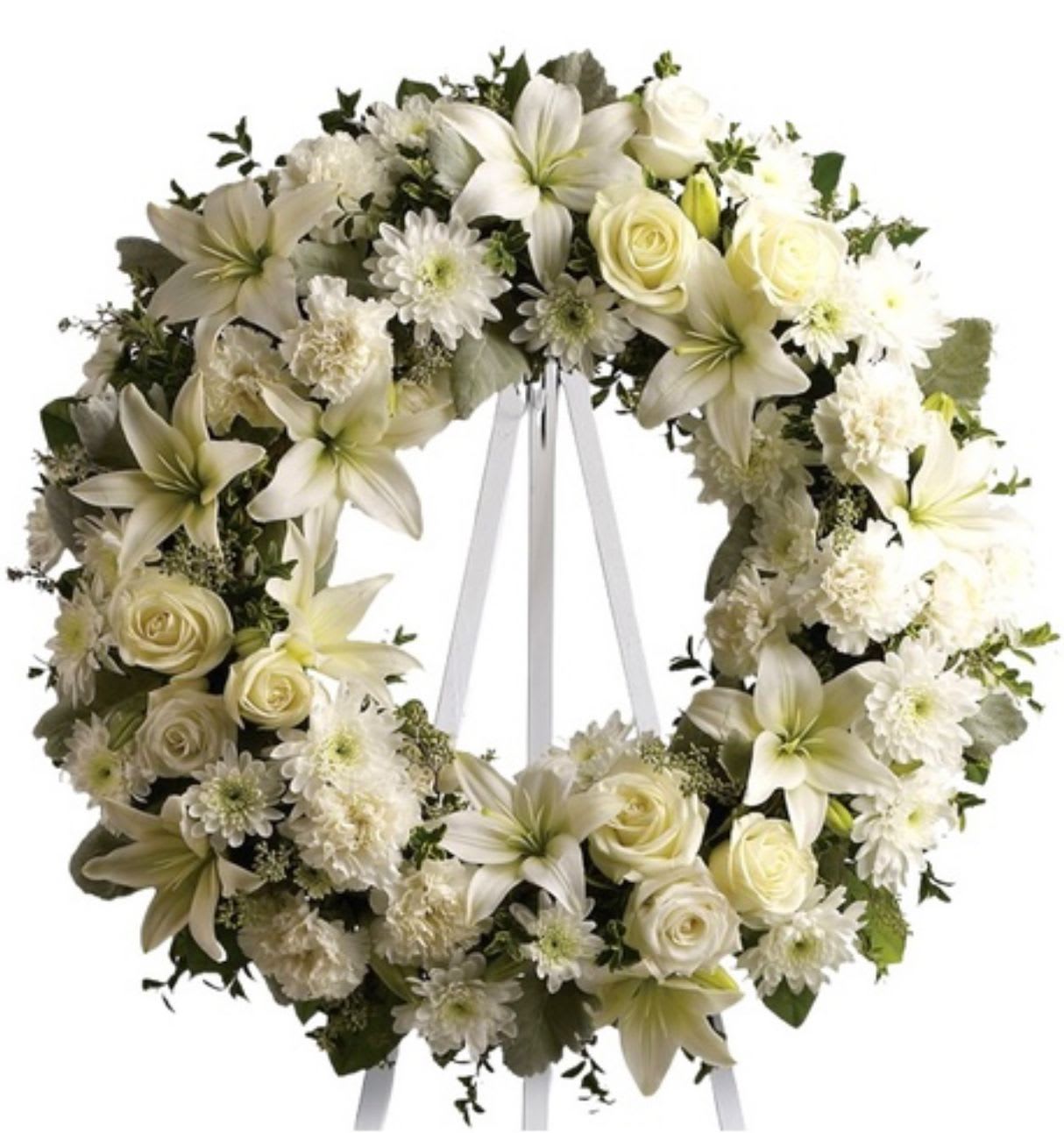 Eternal Serenity Funeral Wreath – White Sympathy Tribute - The Eternal Serenity Funeral Wreath is a timeless circular tribute symbolizing eternal life, love, and remembrance. Designed with an elegant blend of white lilies, roses, chrysanthemums, and carnations, it radiates peace, purity, and heartfelt reverence. Soft greenery enhances the creamy white tones, offering a comforting and dignified presence. Handcrafted by 1800 Blooms, this classic all-white arrangement is perfect for memorial services, funerals, or graveside tributes. Available for same-day delivery across the Bronx, NY.