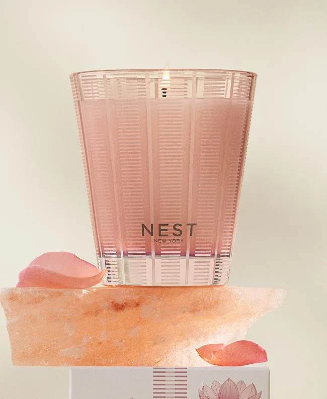 Pink Nest New York candle in a translucent holder with rose petals