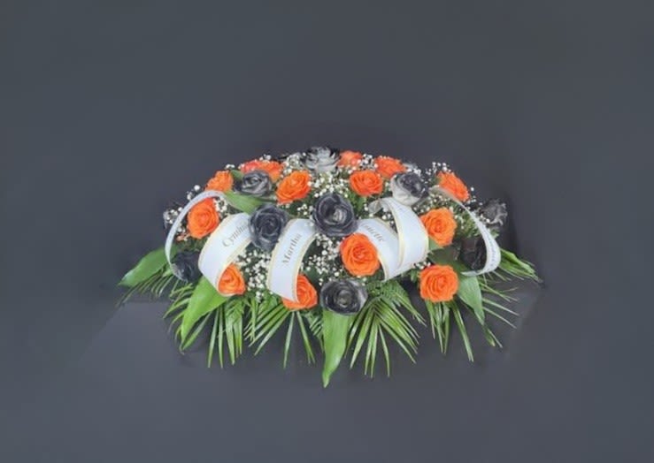 Who Dey Casket Spray - True fandom never ends. Our Who Dey Casket lets your loved one express their Bengal's fandom one last time. Beautiful roses in Orange and Black are accented with white baby's breath to make everyone say WHO DEY!