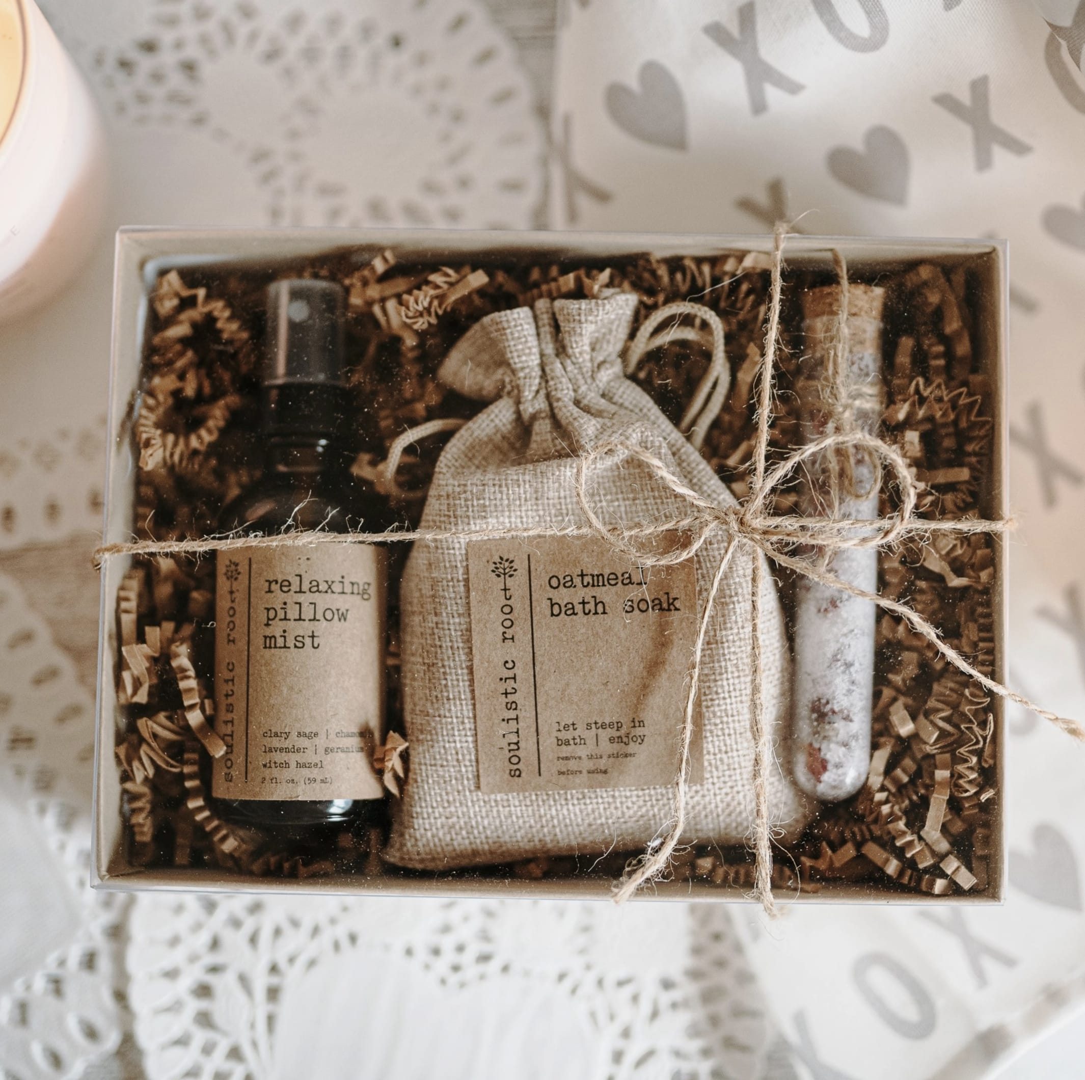 Gift box with a pillow mist bottle, bath soak pouch, and a small vial