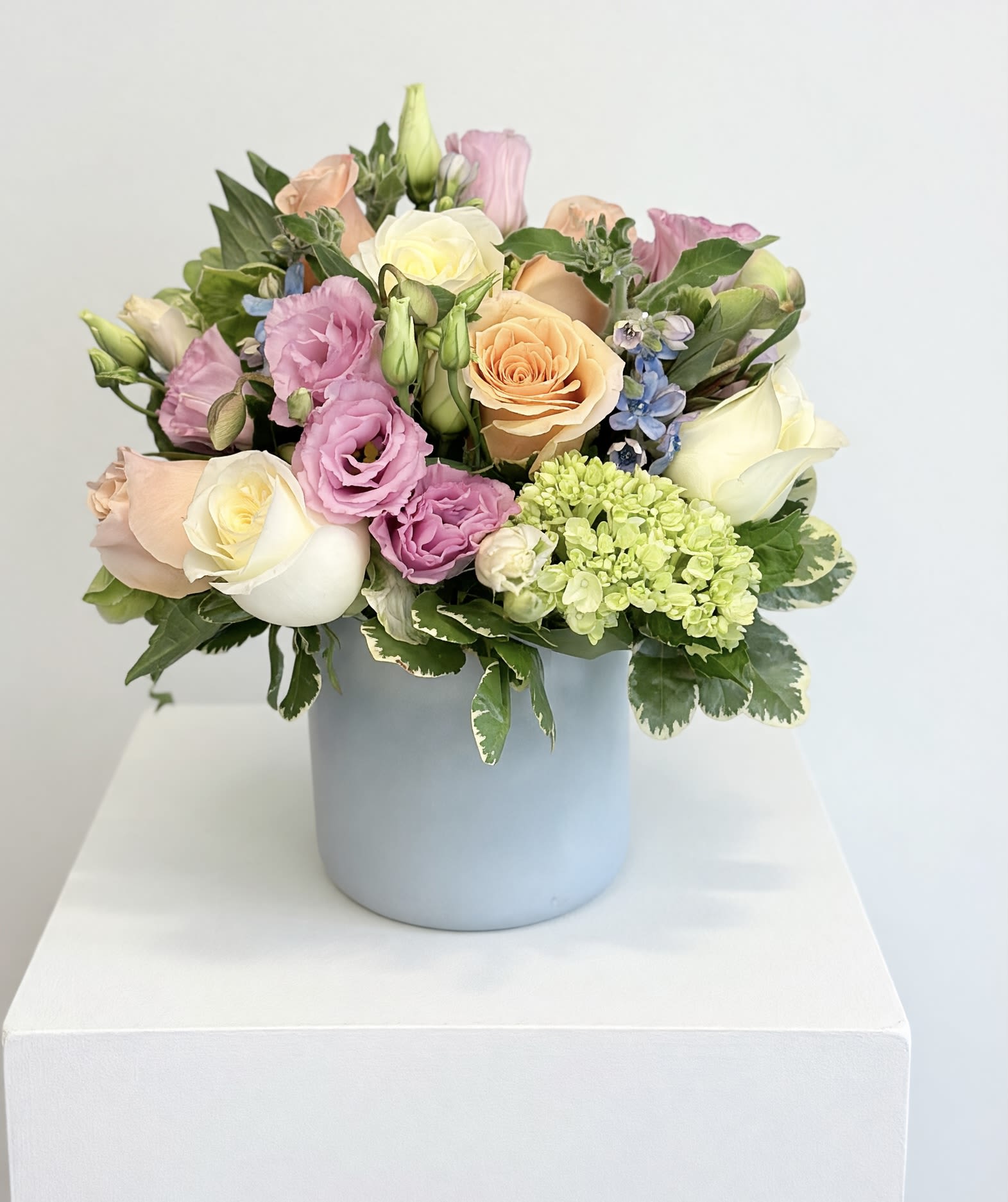 Sweet Harmony  - Send the beauty and freshness of spring with a bouquet featuring peach ranunculus, butter-yellow roses, accented with soft blue tweedia, and pink tulips.
