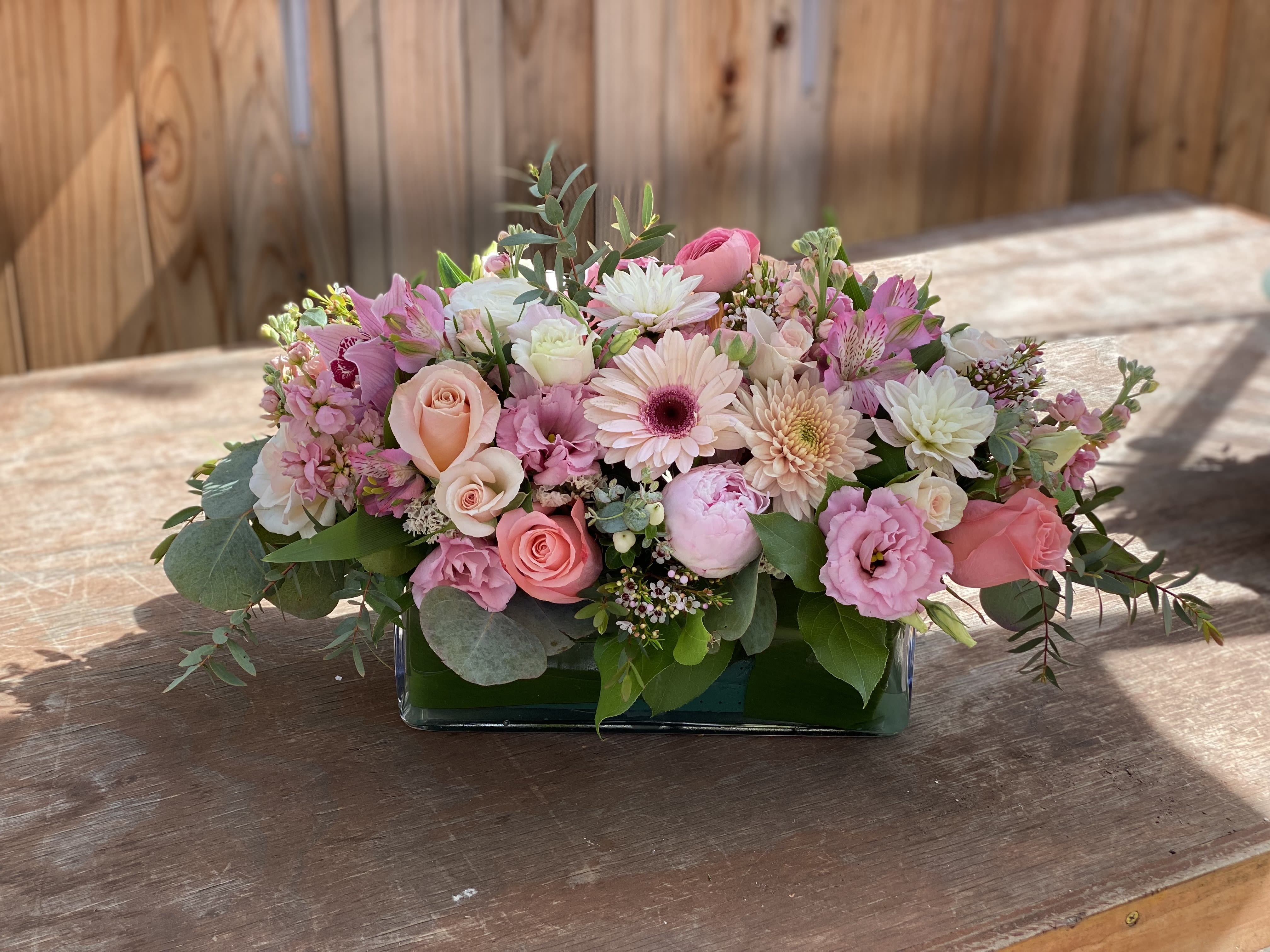 Ella - Delight in an elegant arrangement of vibrant pink blooms! Comes in a glass vase