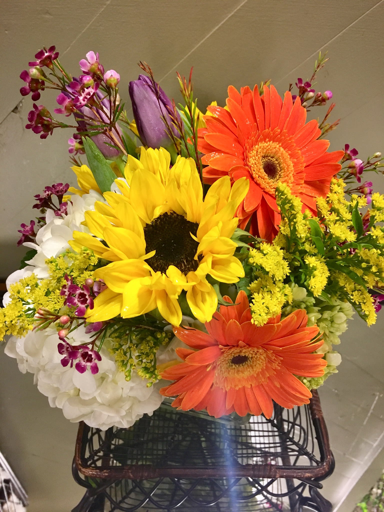 Bright mixed bouquet with sunflowers, orange gerbera daisies, and white hydrangeas