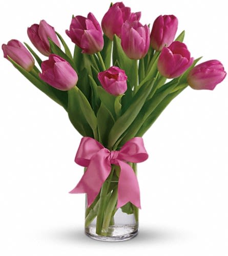 Pink tulips in a clear glass vase tied with a pink ribbon