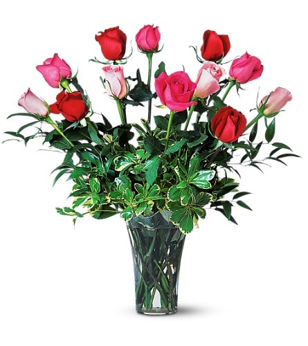 Bouquet of red and pink roses in a clear glass vase