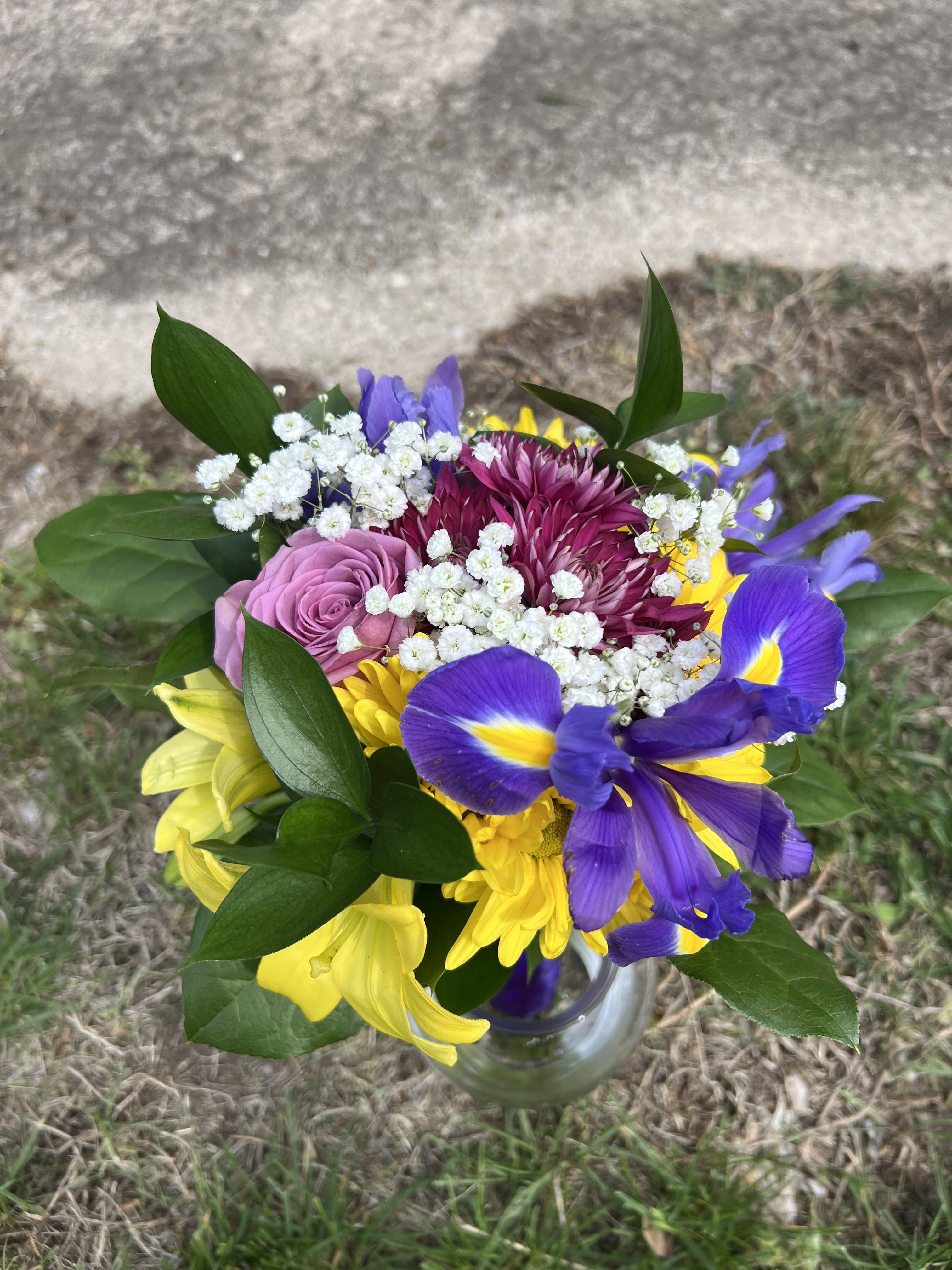 Yellow, Purple &amp; Blue Handheld Bouquet - An elegant and colorful hand-tied bouquet that will compliment any prom outfit. Filled with mixed flowers such as roses, daisies, and iris. *Vase not included*
