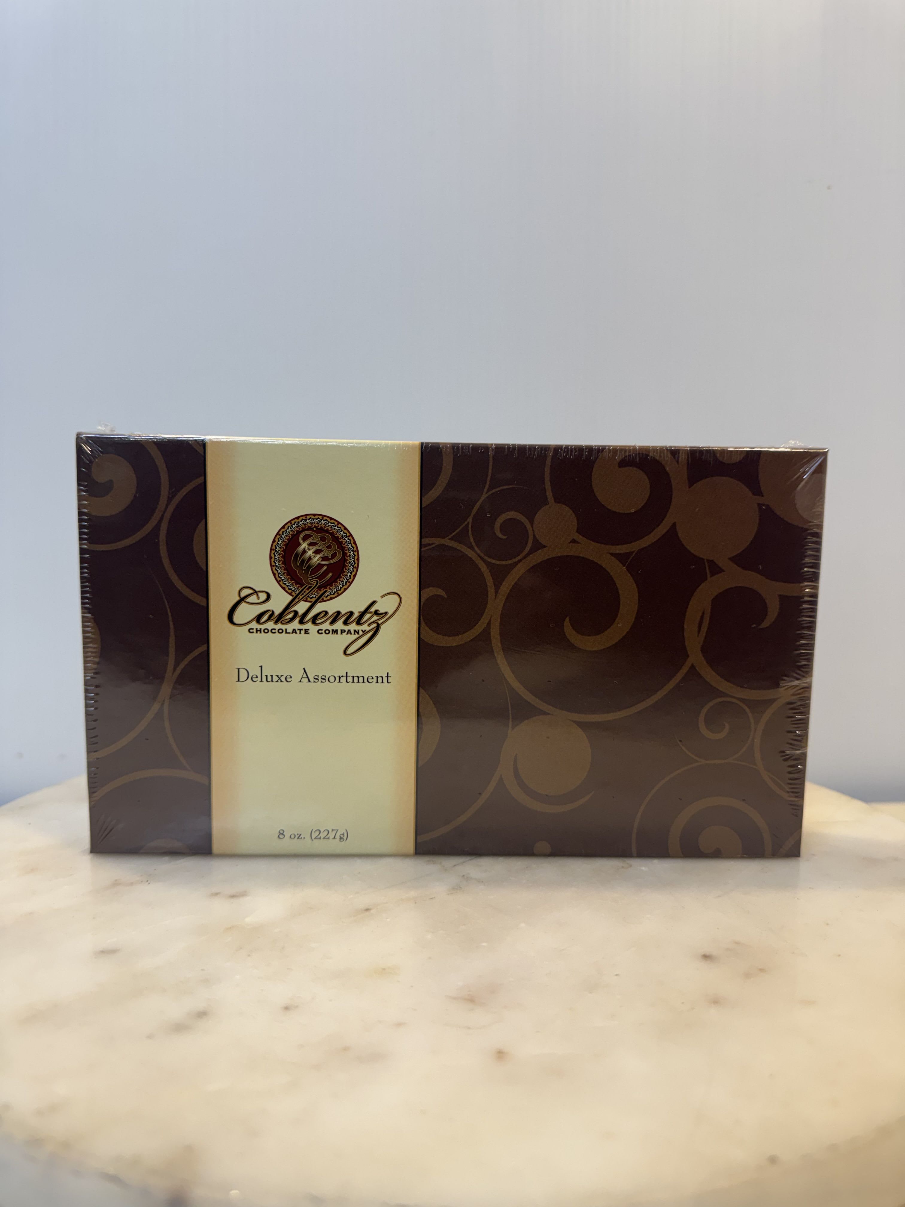 Box of assorted chocolates in brown and cream packaging