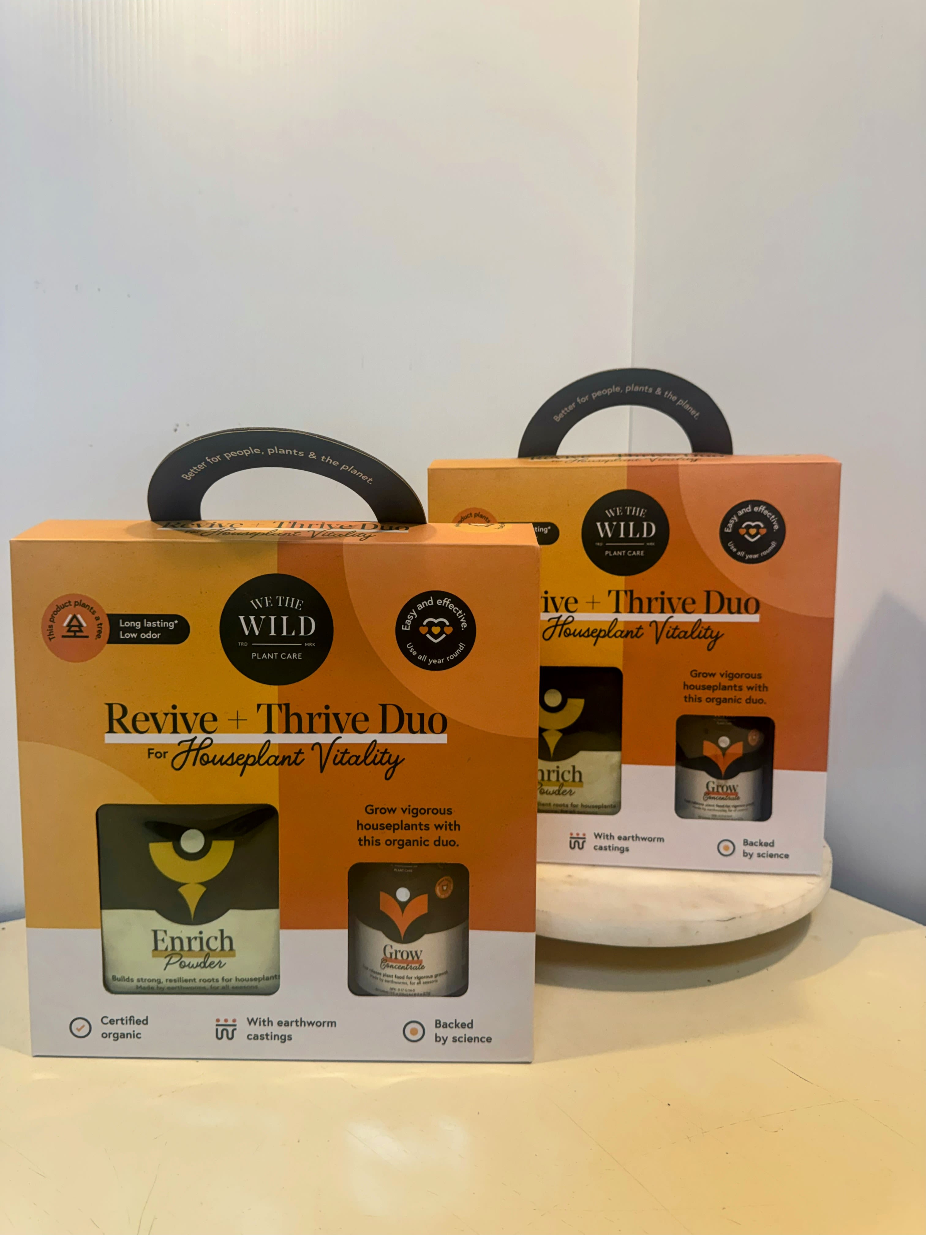 Two plant care gift boxes on a table