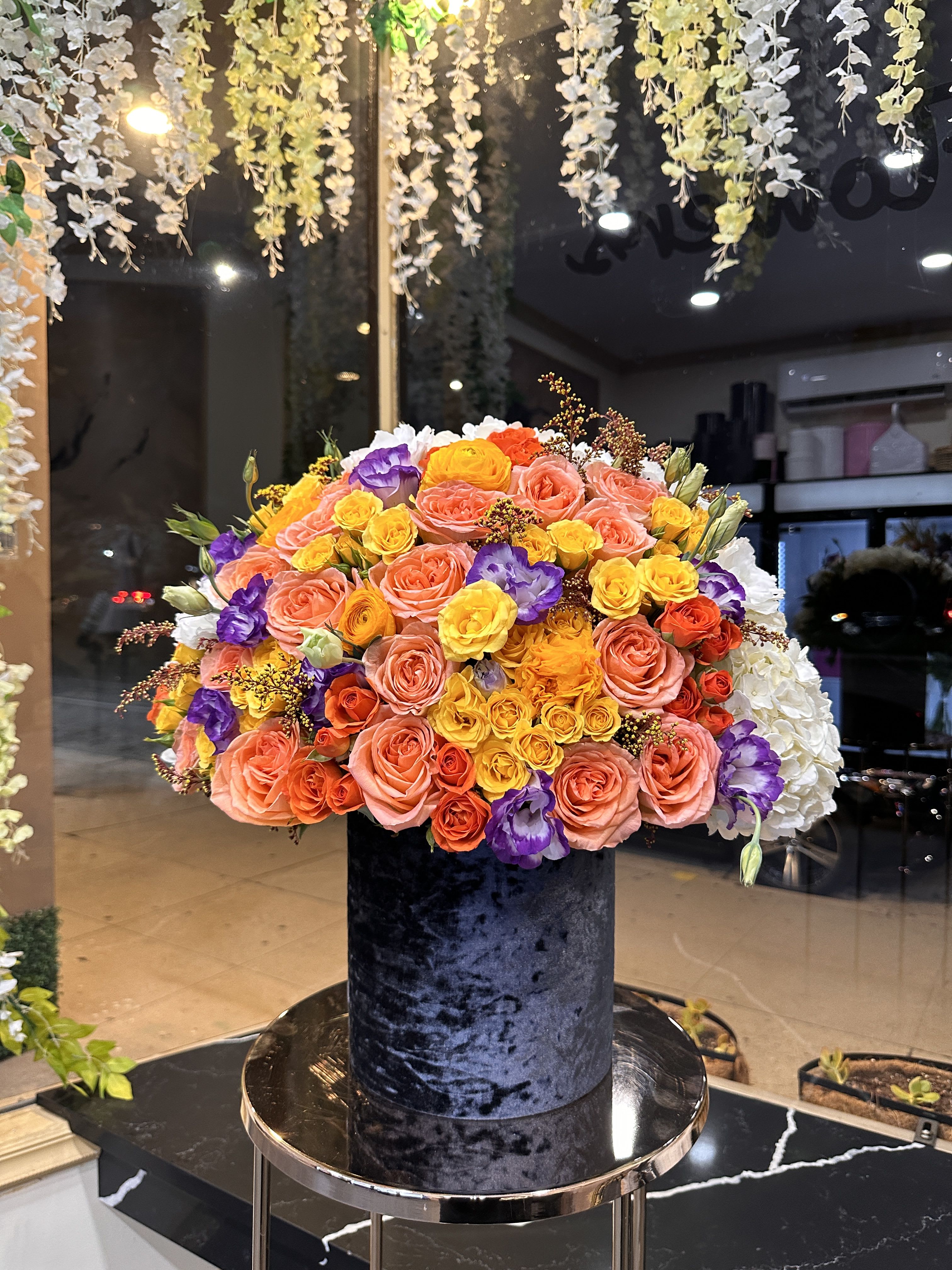 Large mixed bouquet of roses in a black velvet box
