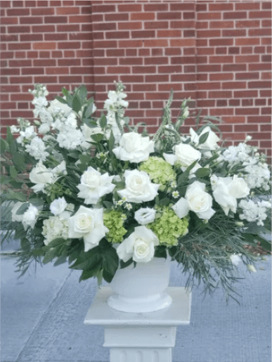 BP75 - Fond Memory - White and green mixed flower arrangement  For a Service: Arranged in a traditional funeral basket.  For Home Delivery: Arranged in a clear cylinder vase.  Please specify in the order comments whether this is intended for a funeral service or a home delivery so we can prepare the appropriate container.  Please Note: Due to seasonal availability, specific flower varieties may occasionally be substituted.   