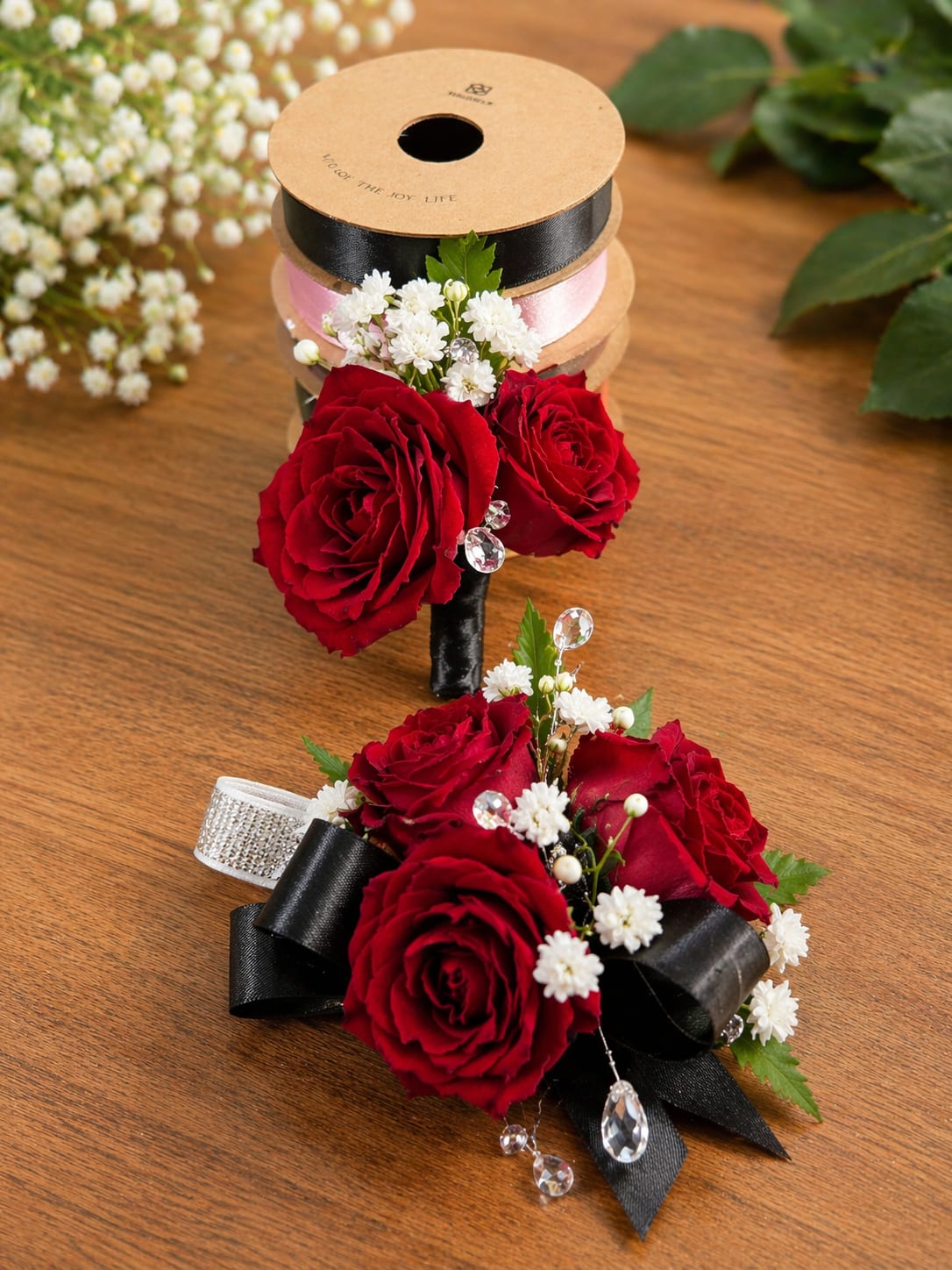 Crimson elegant  - A romantic set featuring rich red roses accented with delicate baby’s breath, greenery, and elegant black satin ribbon with crystal details. Perfect for prom, weddings, or special formal events.