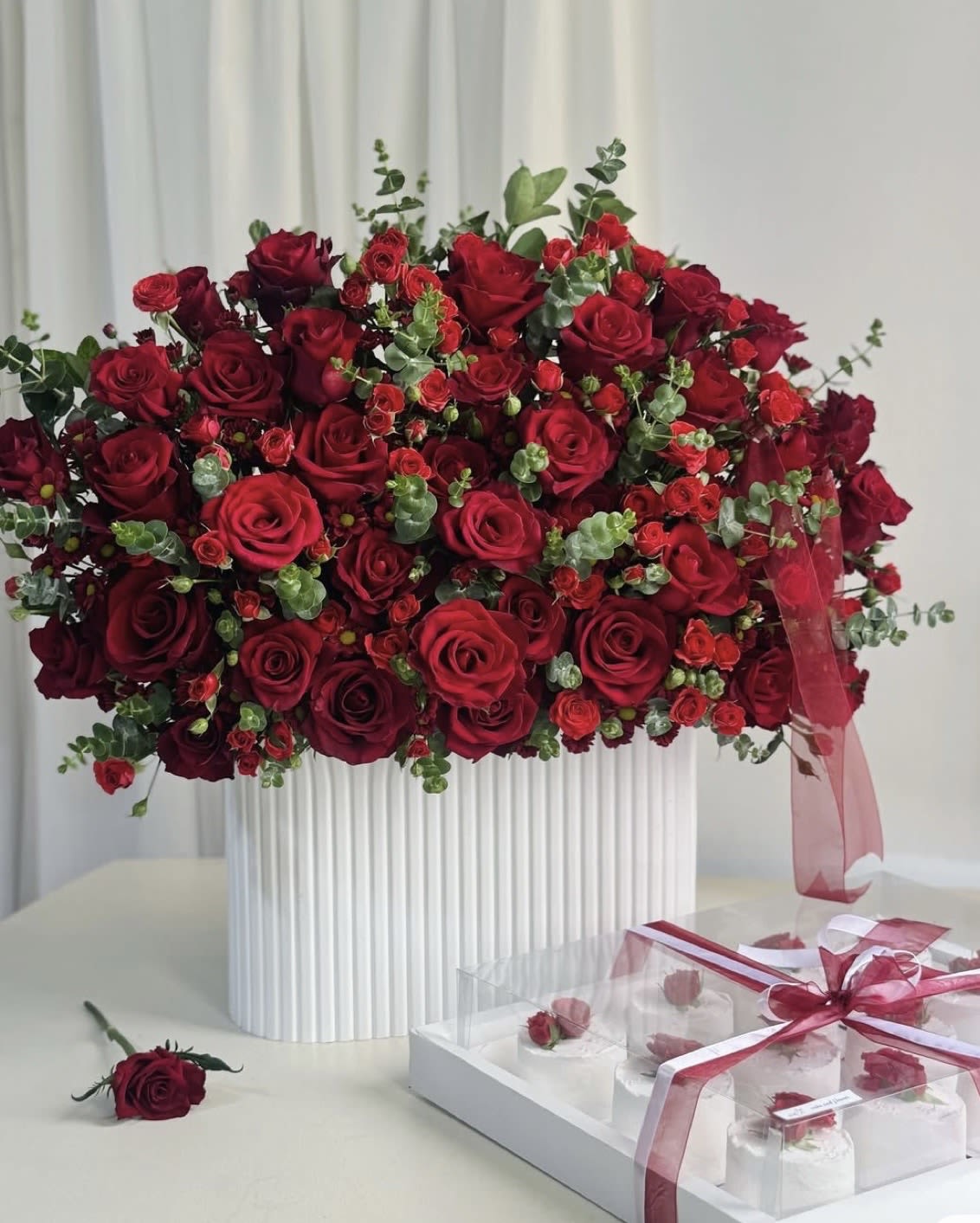 Luxury ceramic vase any colors  -  Grand Luxury Red Rose Arrangement   A breathtaking expression of love, passion, and elegance. This stunning arrangement features premium deep red roses, delicate spray roses, and fresh eucalyptus beautifully designed in a luxurious modern vase — created to leave a lasting impression.  Perfect for: ️ Anniversaries ️ Romantic surprises ️ Valentine’s Day ️ Luxury celebrations ️ Birthday gifts ️ Special unforgettable moments   Premium fresh roses  Elegant luxury design  Sophisticated modern vase included  Perfect for grand romantic gestures  Same-day delivery available  When ordinary flowers are not enough — choose extraordinary beauty.  Send love in its most luxurious form tod