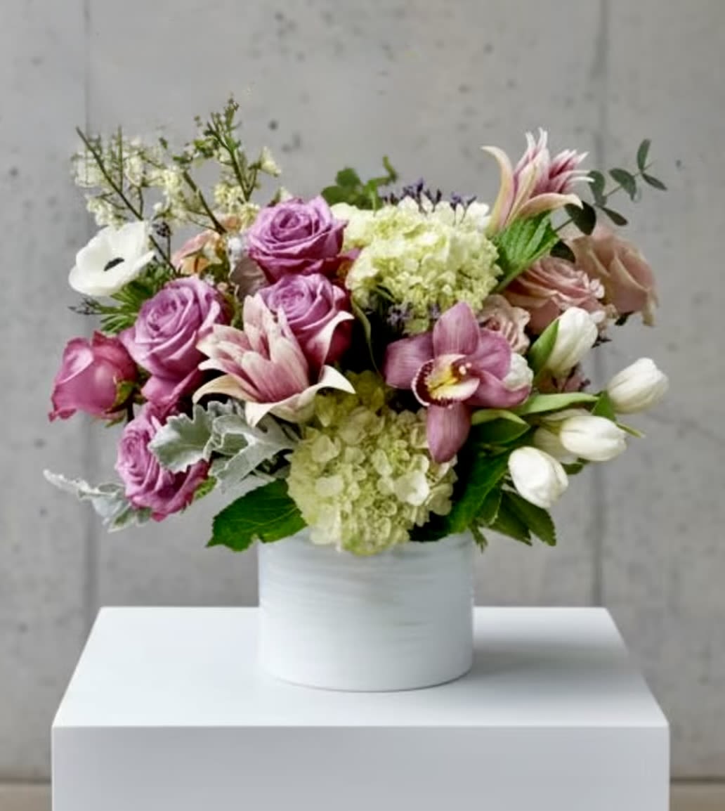 Primavera Luxe  - A breathtaking arrangement of premium spring blooms in a harmonious blend of soft pastels and vibrant hues. Designed with elegance and sophistication, this upscale composition captures the essence of renewal and beauty. Approximate size: 14" x 18".