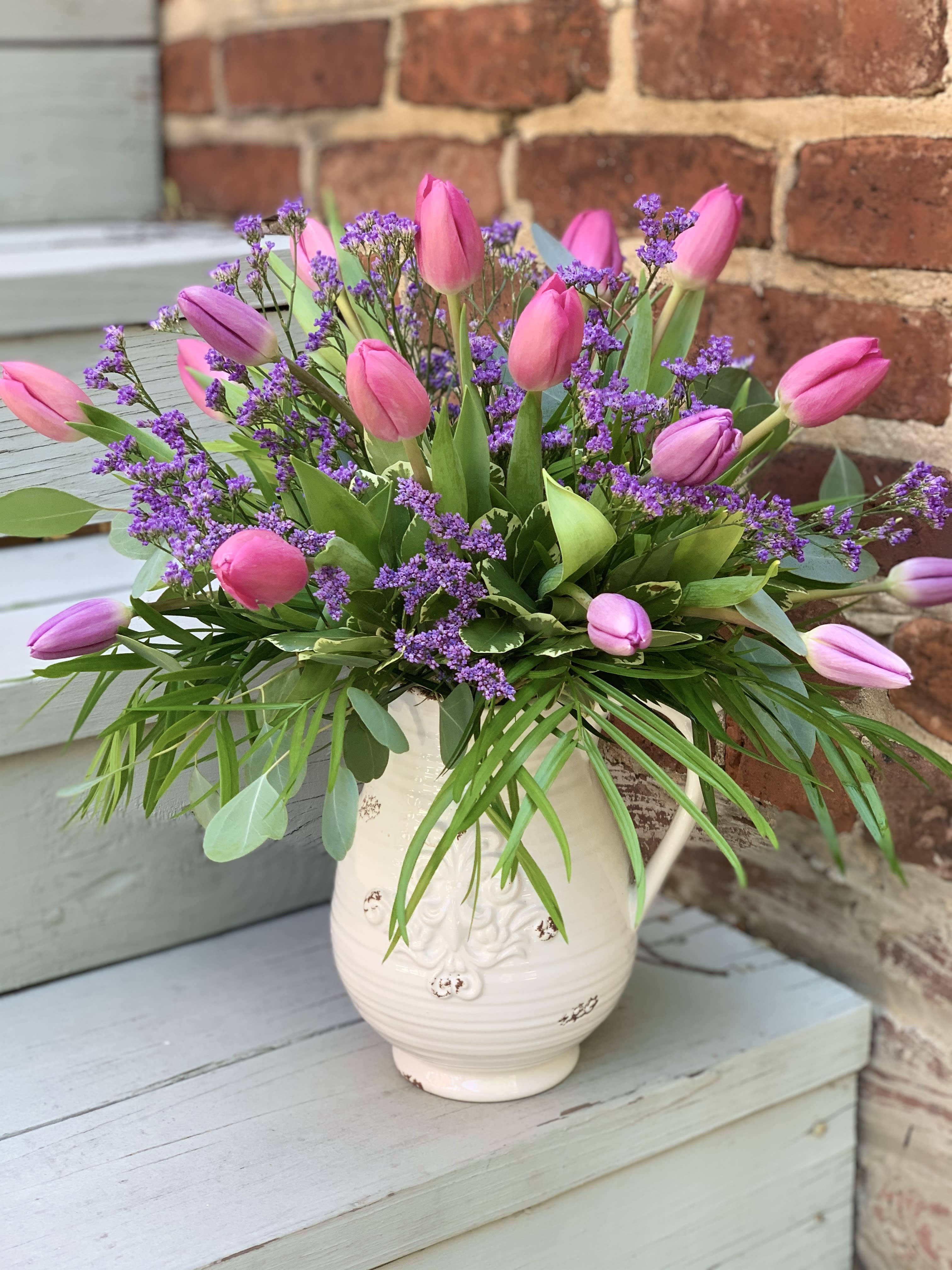 Tulips For Mom  - Mixed Tulips Arrive in a Decortive Ceramic Pitcher With Filler and Mixed Greenery. 