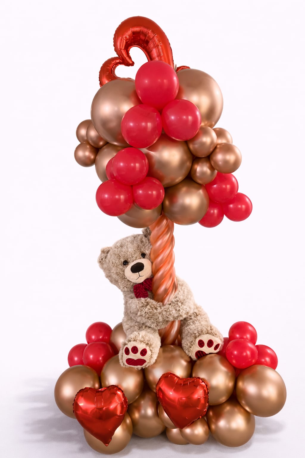 Teddy bear with red and gold heart balloons