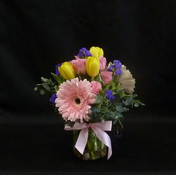 Cutie Pie - Sweet and Simple, this little "Cutie Pie" is perfect for many occasions when you want to say "You are special"!  Pinks and yellows, with gerbera daisies, spray roses and tulips in a mini clear glass jar.