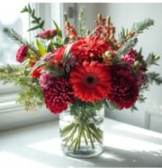 Pine for the Deep - Fresh and real Christmas greens create a bed for deep burgundy and red carnations and a touch of red gerbera and green hypericum berries
