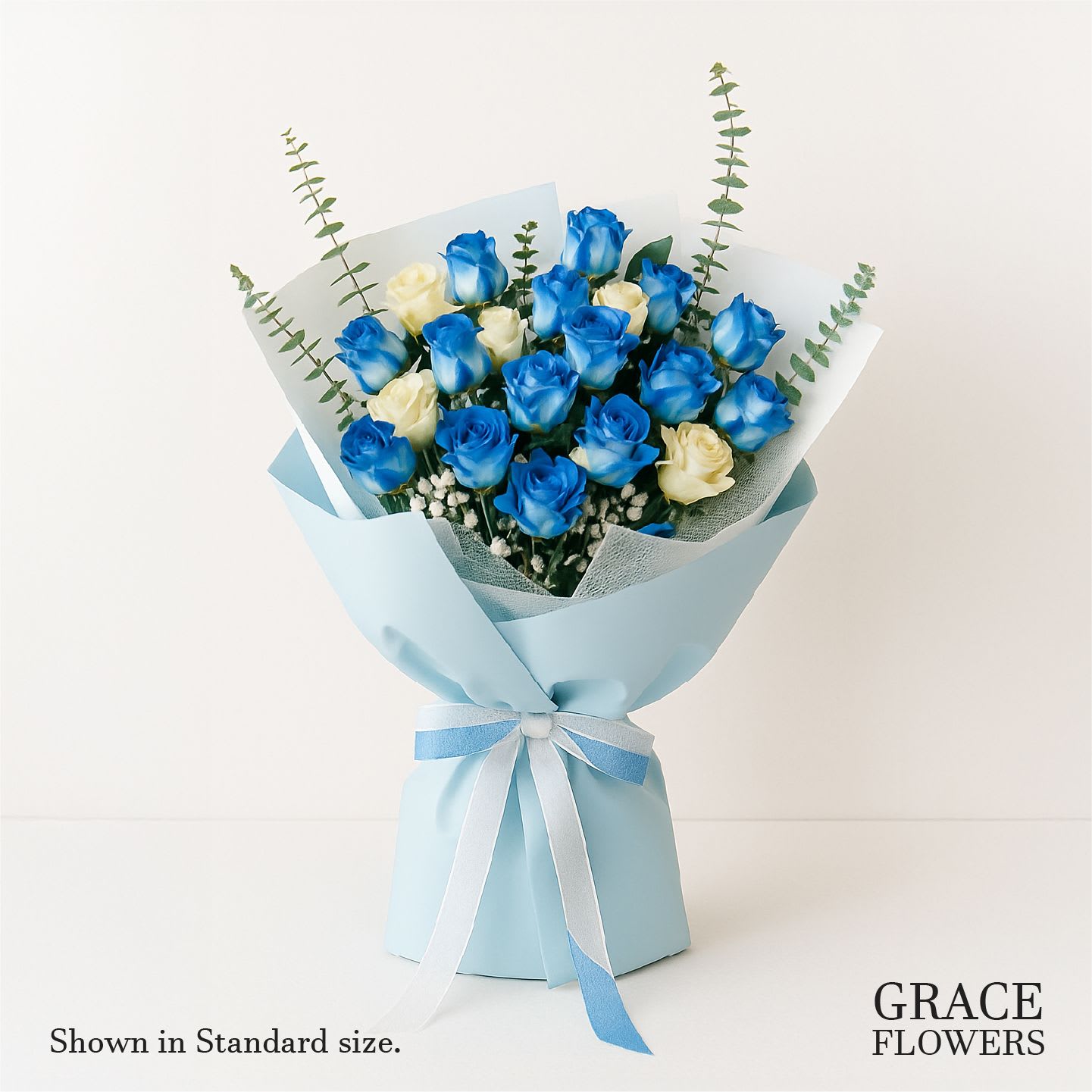 Blue and cream rose bouquet wrapped in light blue paper
