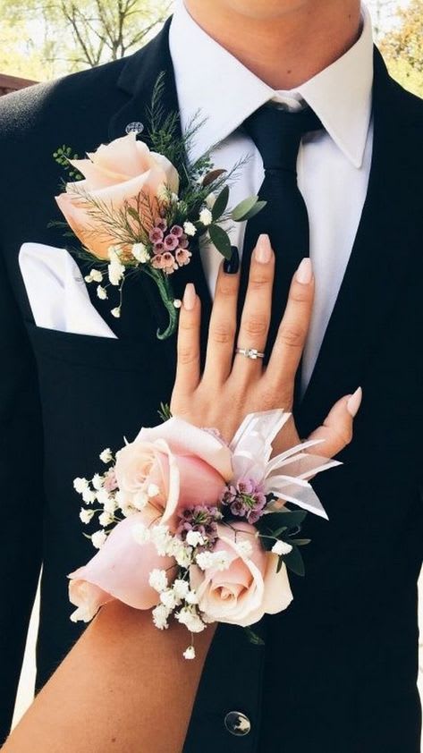 Boutonniere and wrist corsage with pale pink roses on formal attire