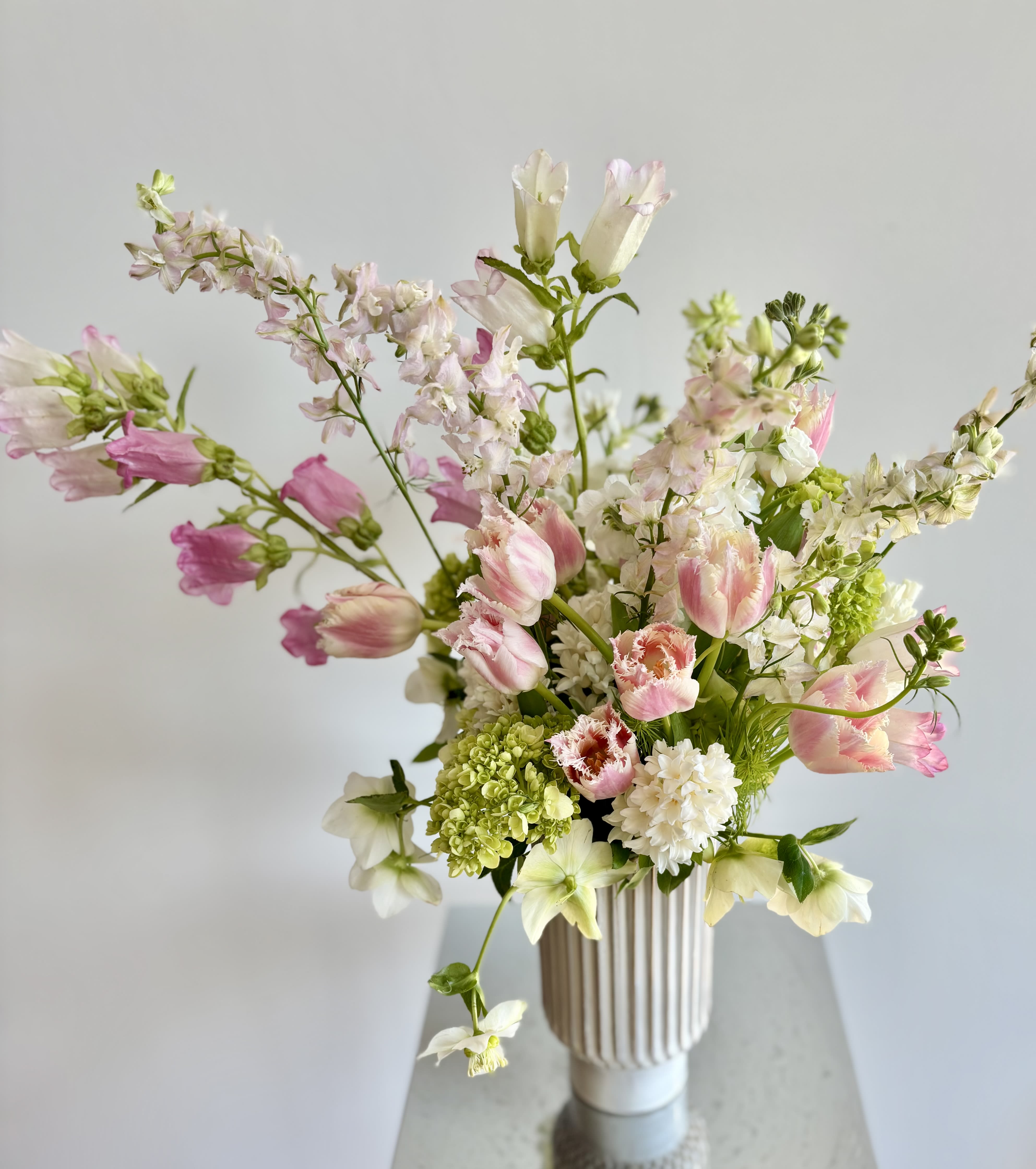 Pink and white mixed bouquet in a ribbed vase