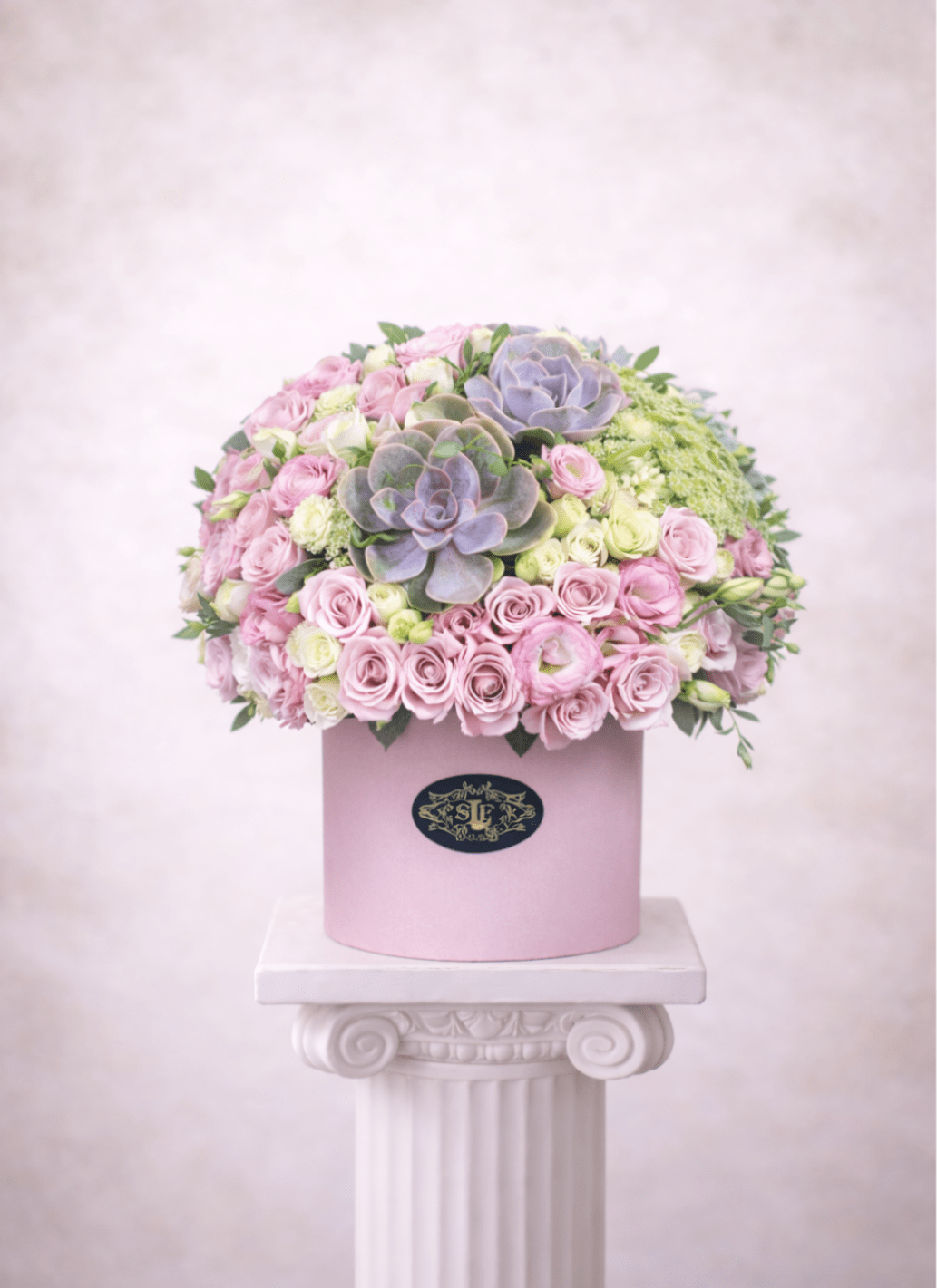 Blushing Beauty  - Brighten any space with our Elegant Flower Box Arrangement! Bursting with vibrant blooms, this stunning display combines seasonal favorites with lush greenery.   Housed in a chic, reusable container, it makes a perfect centerpiece for any occasion be it a gift or a treat for yourself. Elevate your decor with this captivating arrangement that brings joy and sophistication to your home or office. Order yours today and let the beauty of flowers inspire you!