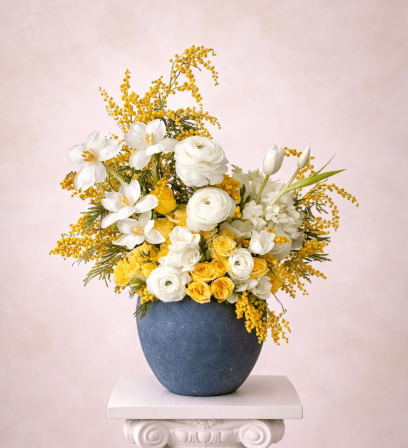 White and yellow flowers arranged in a blue vase