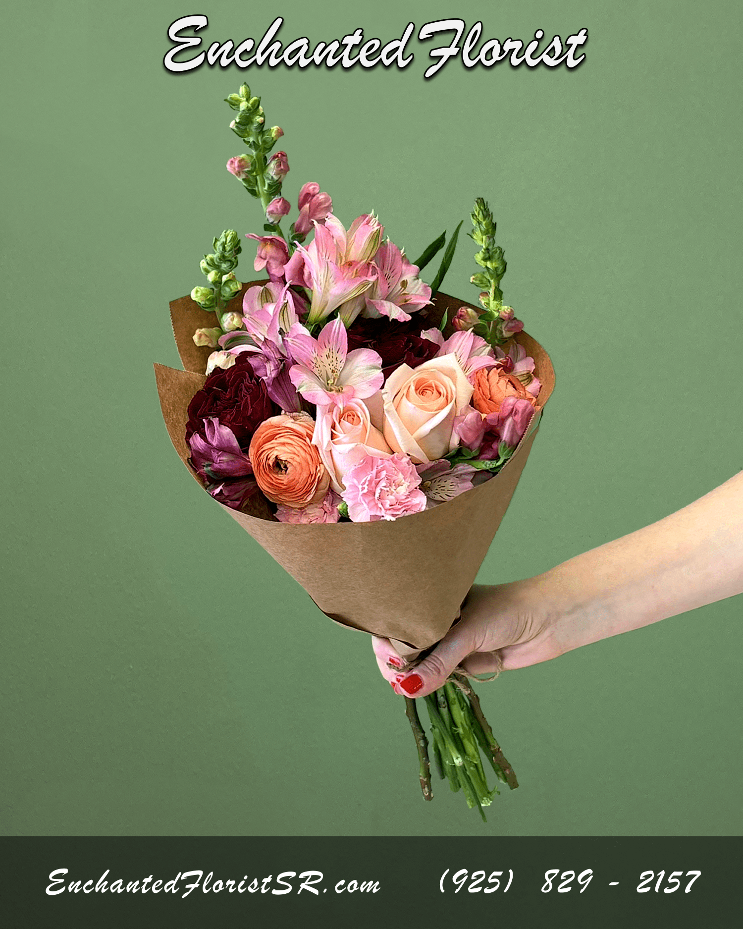 Hand-tied bouquet of pink and peach roses, ranunculus, and mixed blooms wrapped in brown paper.