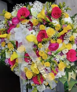 Moment of Peace - Bright pink and sunny yellow roses with white accents, yellow calla lilies and daisies, finished with a sheer ribbon-cheerful, celebratory bouquet for a vibrant life.