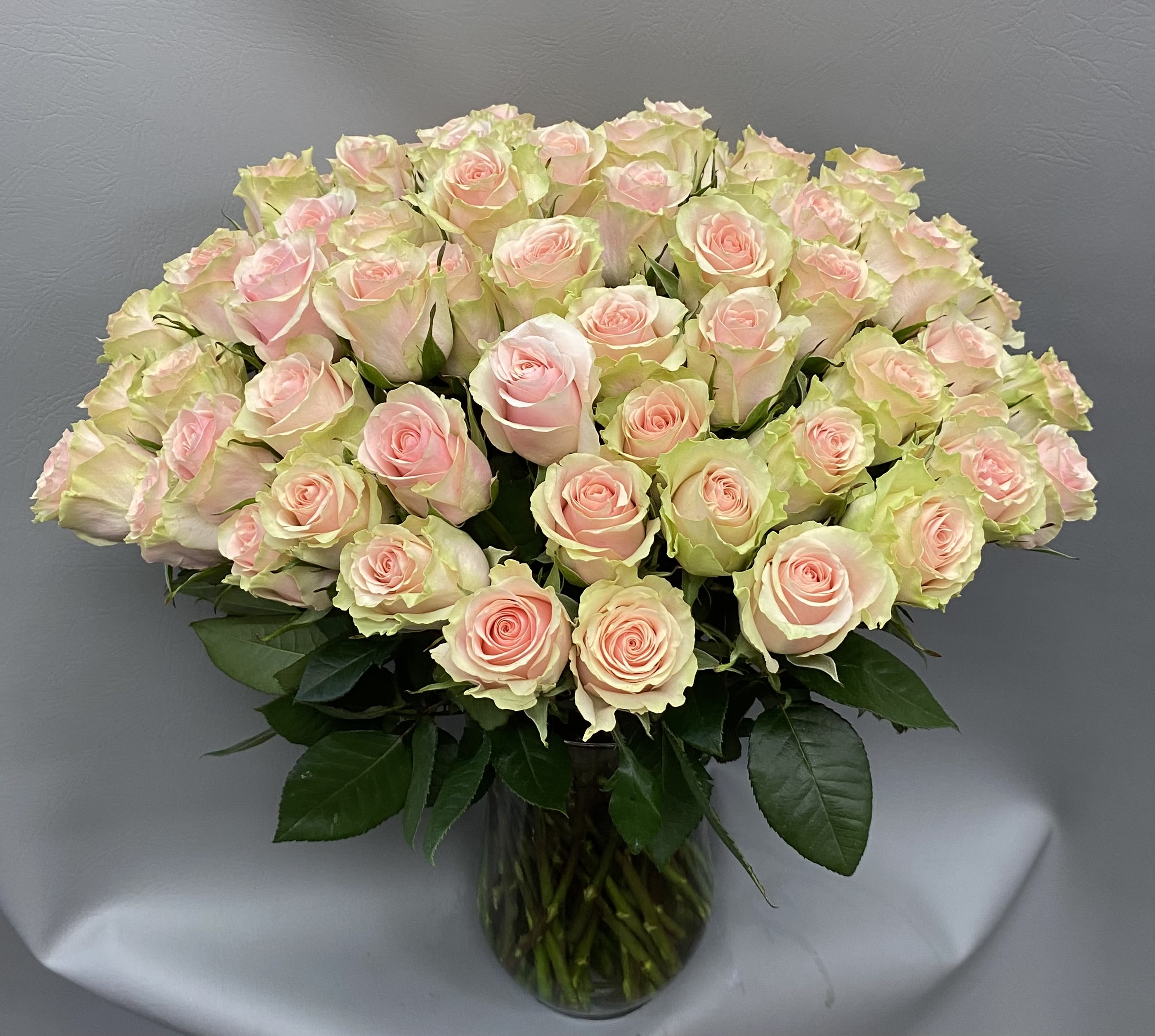 Bouquet of pale pink roses in a clear glass vase