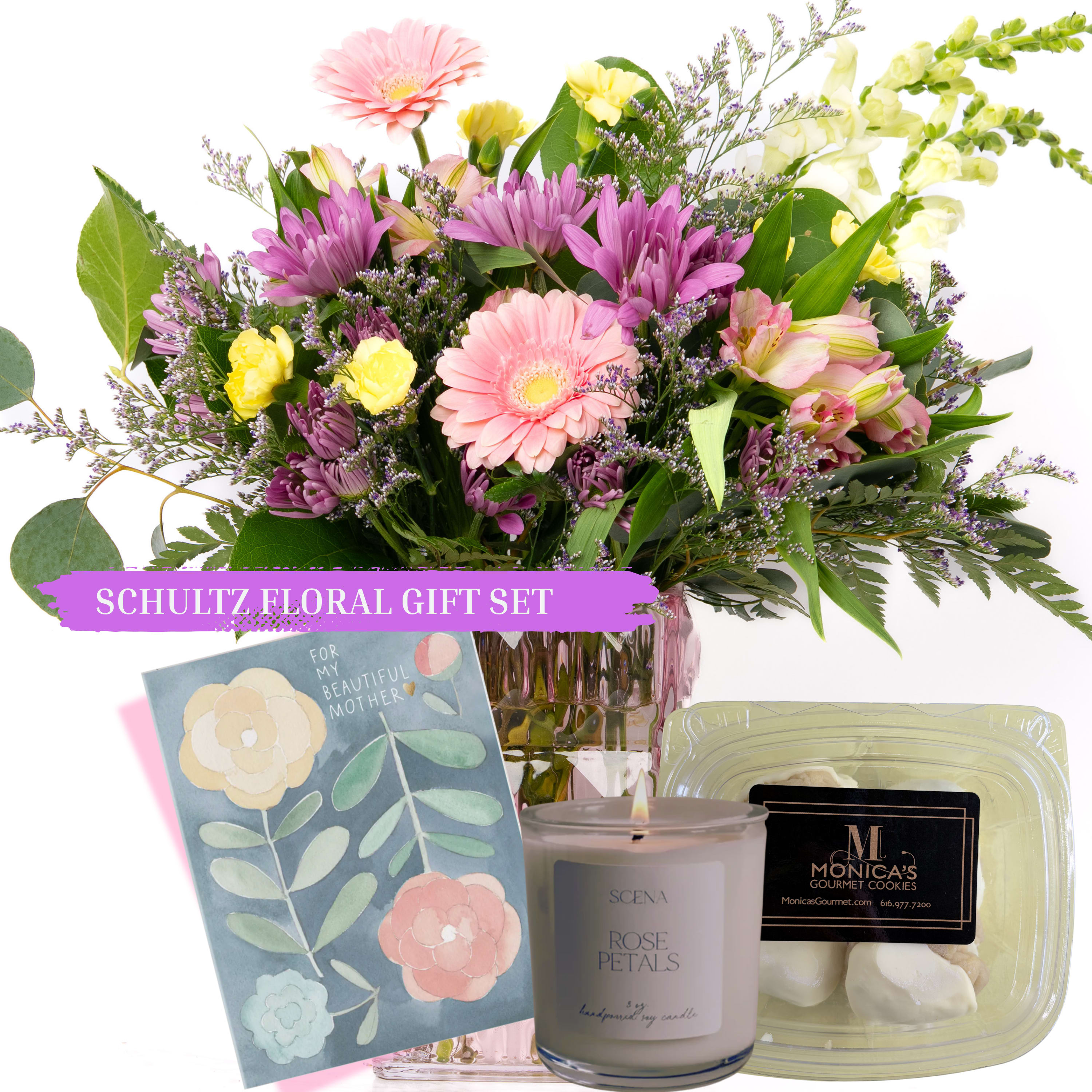 Our Mother's Day Collection: Ophelia Gift Set by Schultz Floral - Celebrate your dazzling Mom this Mother's Day with our Gerbera Daisy floral mix in an elegant pink vase. This gift set for her is paired with gourmet mini cookies, a locally poured candle (8 oz.), and a handwritten Mother's Day card. We've made it easy to say "Thank you for being amazing, Mom."  This gift bundle includes: - One Ophelia floral arrangement in a pink vase - One half-dozen box of gourmet mini cookies.  - One 8 ounce locally poured "Rose Petals" candle (Natural soy candle with cotton wick) - One handwritten Mother's Day card (designs will vary; include a your personal message during check out)  Note: Available for Local Delivery or Valparaiso Pick Up May 6 - May 24, 2026
