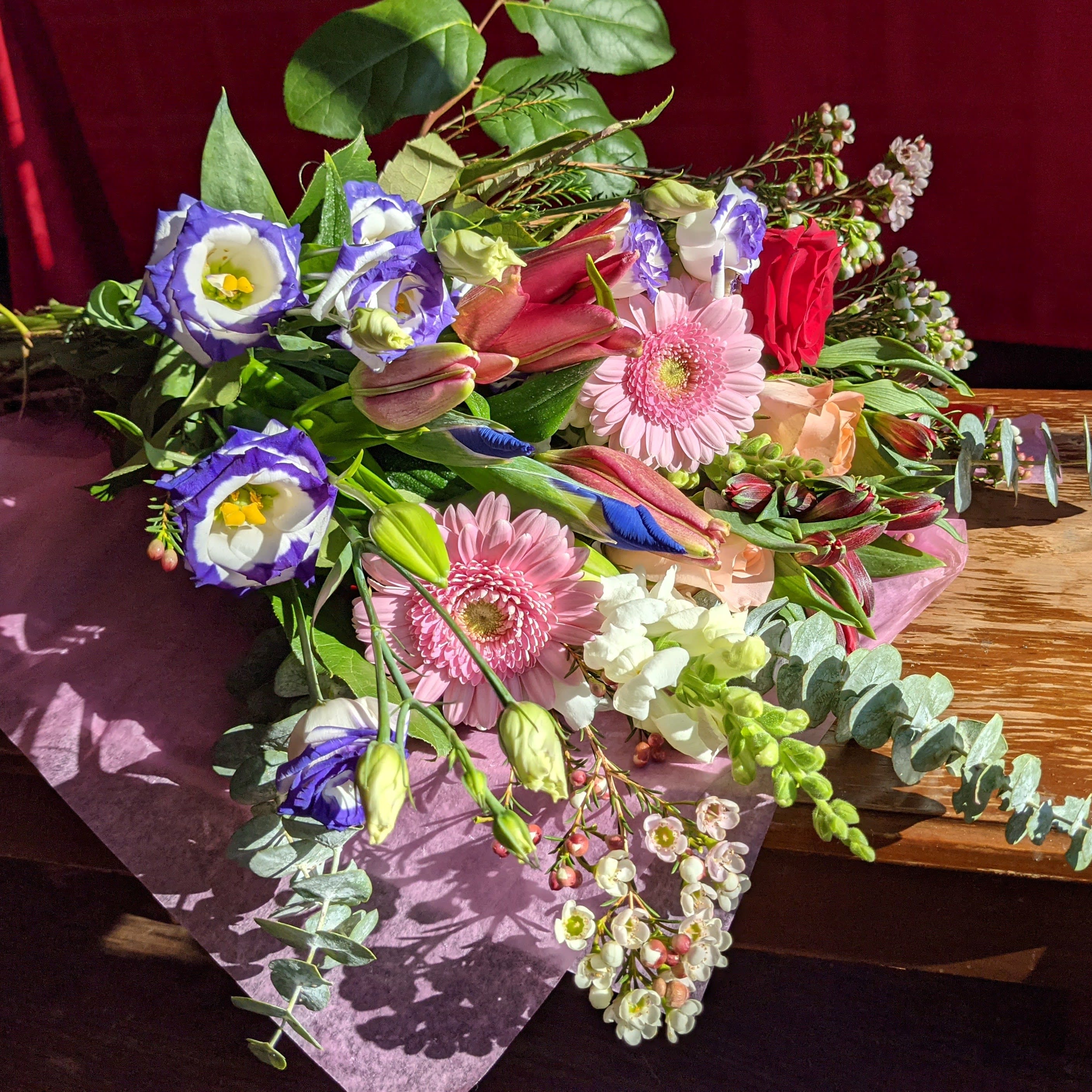 Designer's Choice - Hand Tied Bouquet - Skip the vase and send this beautiful arrangement mixed flowers to your special someone.  This flower arrangement is created with the expert touch of one of our skilled designers. This popular arrangement features a breathtaking array of blooms, hand-selected for their seasonality and beauty. Whether you're sending a heartfelt message of love and appreciation, or simply expressing your gratitude for a job well done, the Designer's Choice arrangement is the perfect choice.  With its stunning combination of color and texture, this custom flower arrangement is sure to leave a lasting impression on anyone who receives it. So why not take a moment to sit back, relax, and let us create something truly special for you?  Please note that all pictures shown are just examples of the Designer's Choice arrangements and specific requests cannot be accommodated through this ordering option. If you would like to place an order for a custom flower arrangement, we invite you to call our store directly.