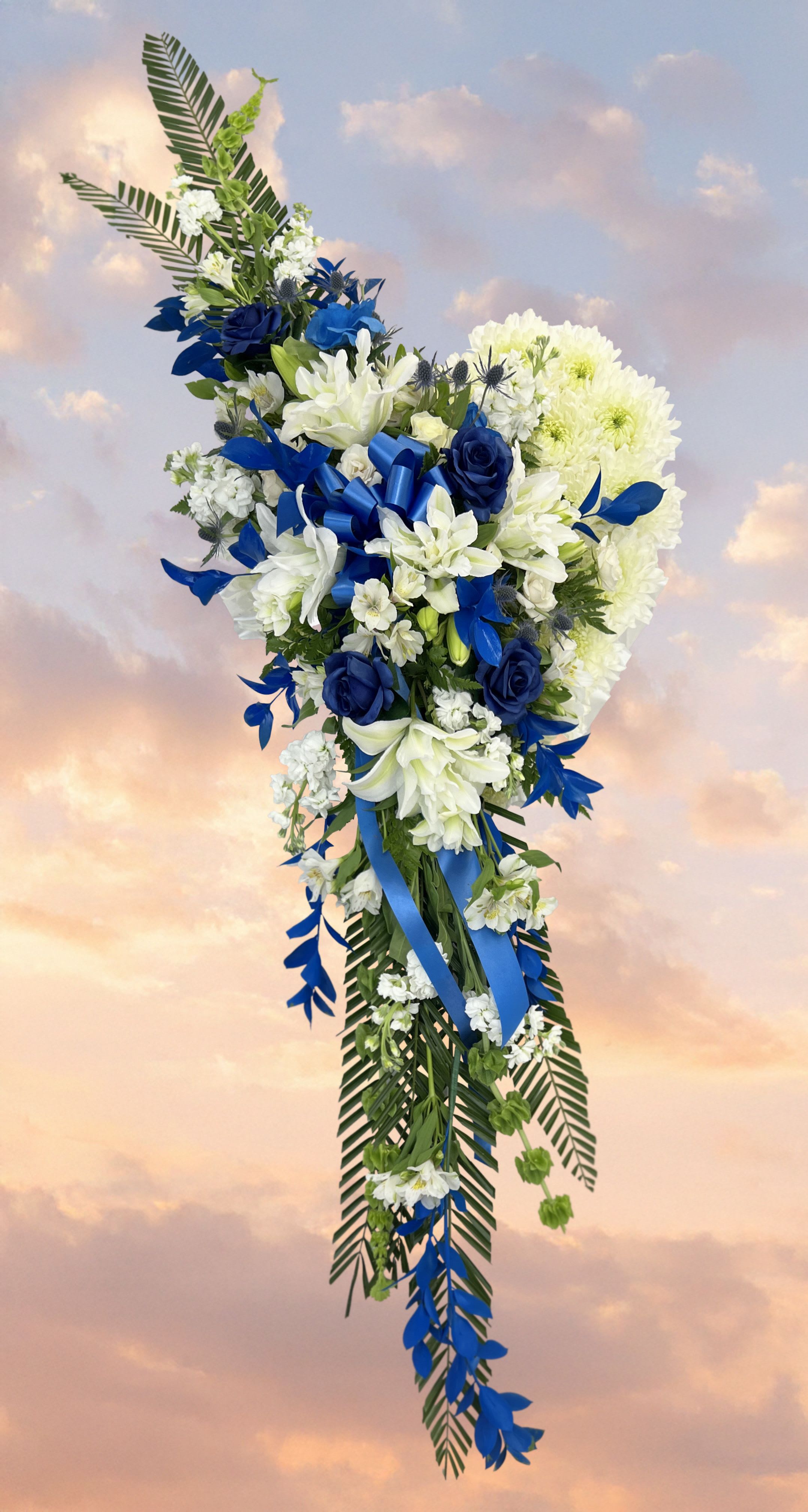 Blue and white floral standing spray with ribbon accents