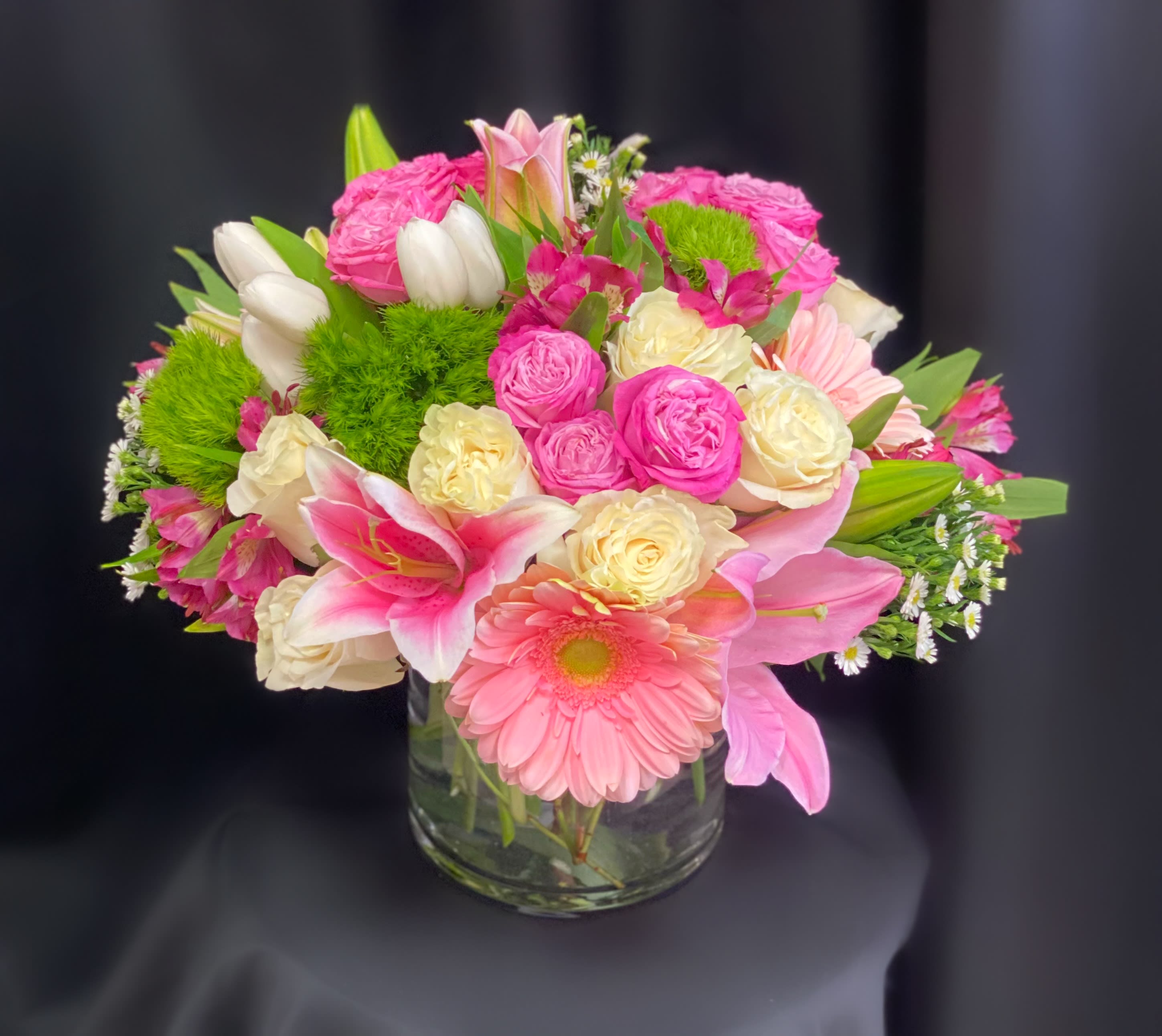 Pink and cream mixed bouquet in a clear glass vase
