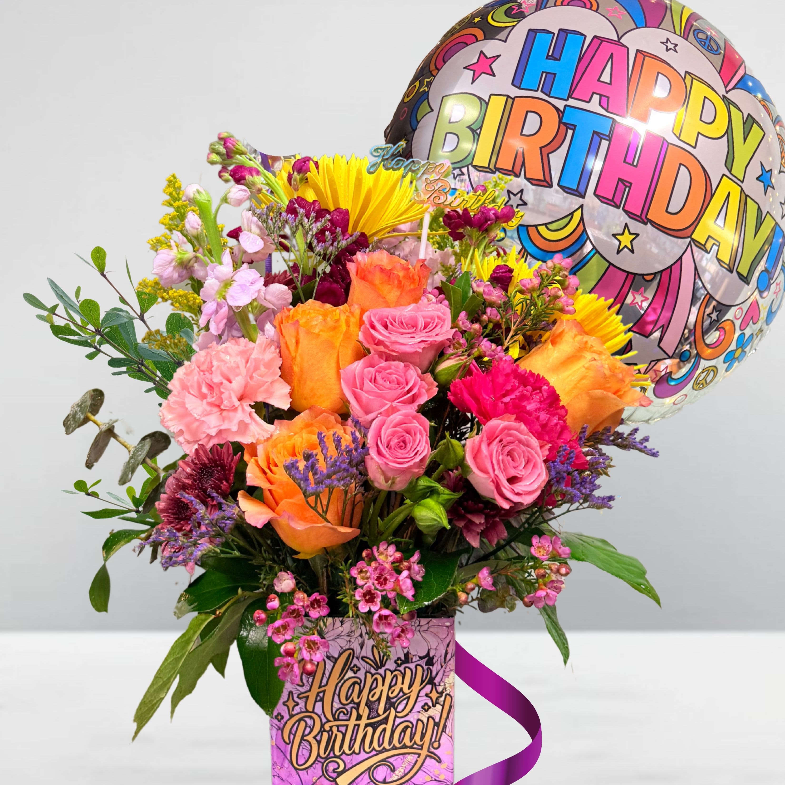 Colorful birthday bouquet with roses and a balloon