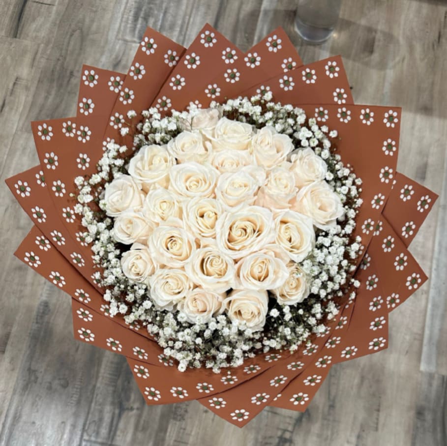 Oyita Bouquet - Ayita hand wrapped bouquet, With 2 dz white ecuadorian roses, surrounded with mini white flowers and oyita wrapping paper.  This bouquet is great for anniversaries, national girlfriend day, congratulations, happy birthday.