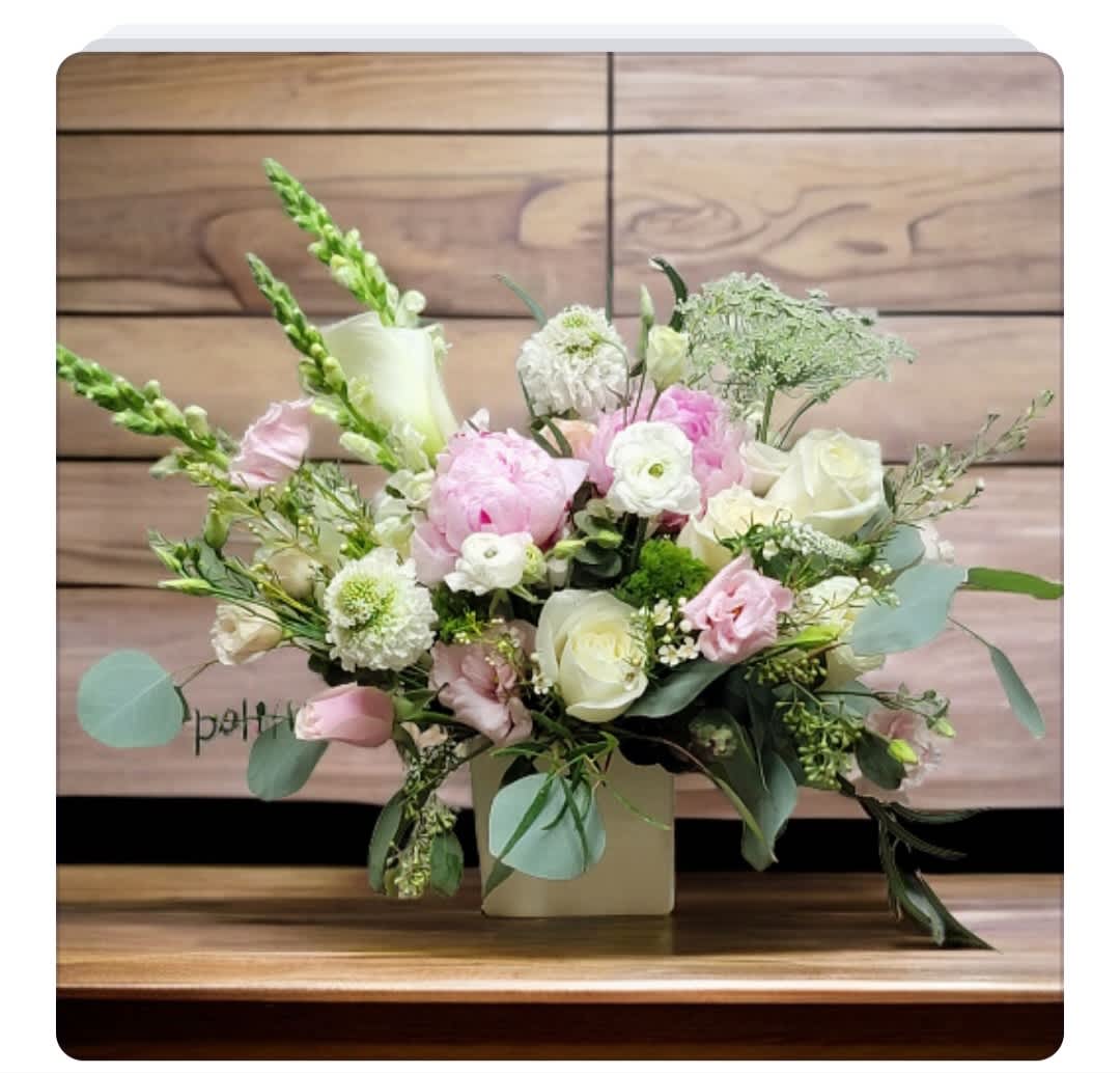 Pink and white floral arrangement in a square vase